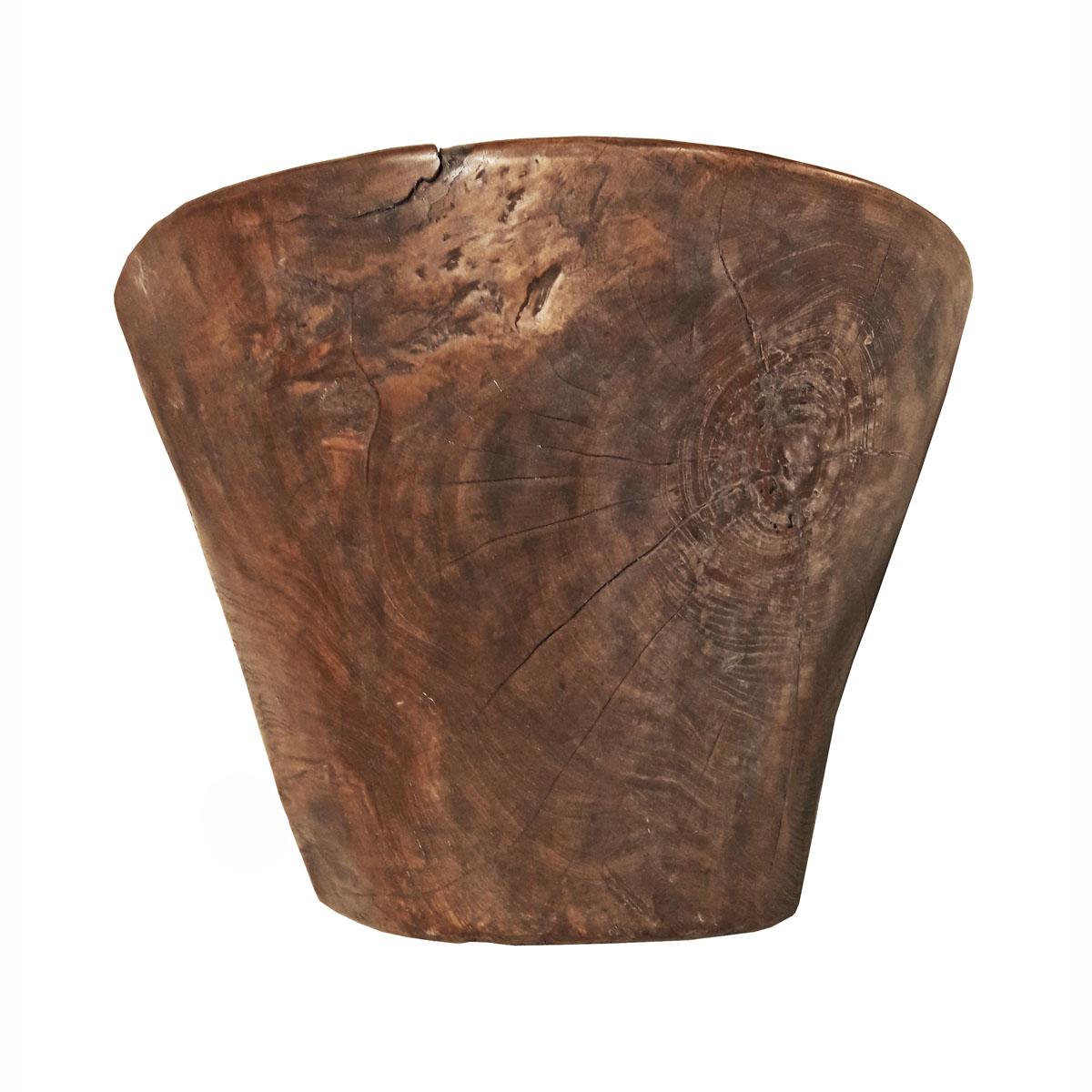 A large teak wood bowl from Indonesia, circa 1960. 

Hand carved from a single piece of solid wood, the distressed appearance of this piece makes it an attractive focal point in any rustic or Minimalist decor. Can be used as a planter or cachepot, a
