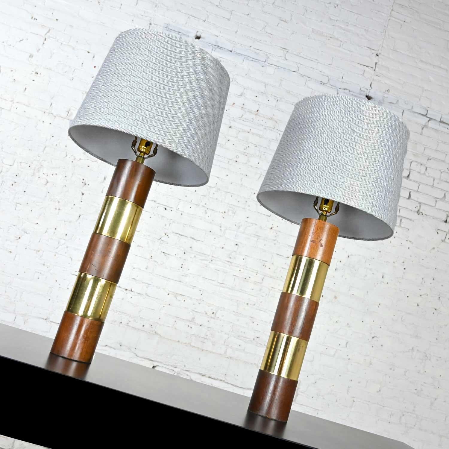 Stellar wood & brass plate pair of lamps in the style of Milo Baughman for Thayer Coggin. New hardback tapered drum shades in black & white tweed fabric. Beautiful condition, keeping in mind that these are vintage and not new so will have signs of