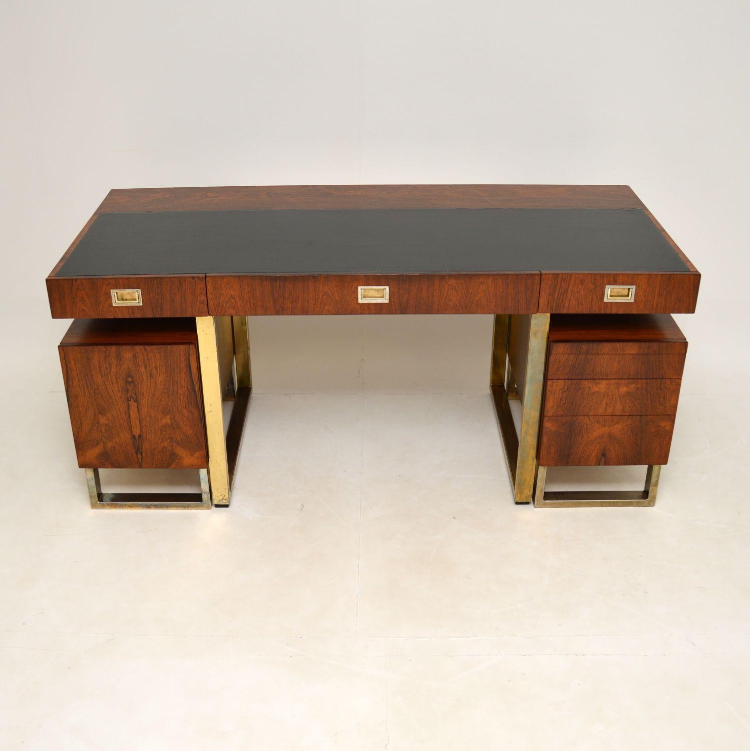 A magnificent and very rare vintage partners desk, beautifully made from wood, leather and brass plated steel. This was made in England, it dates from the 1960’s.

The quality is absolutely outstanding and this is a most impressive piece. The