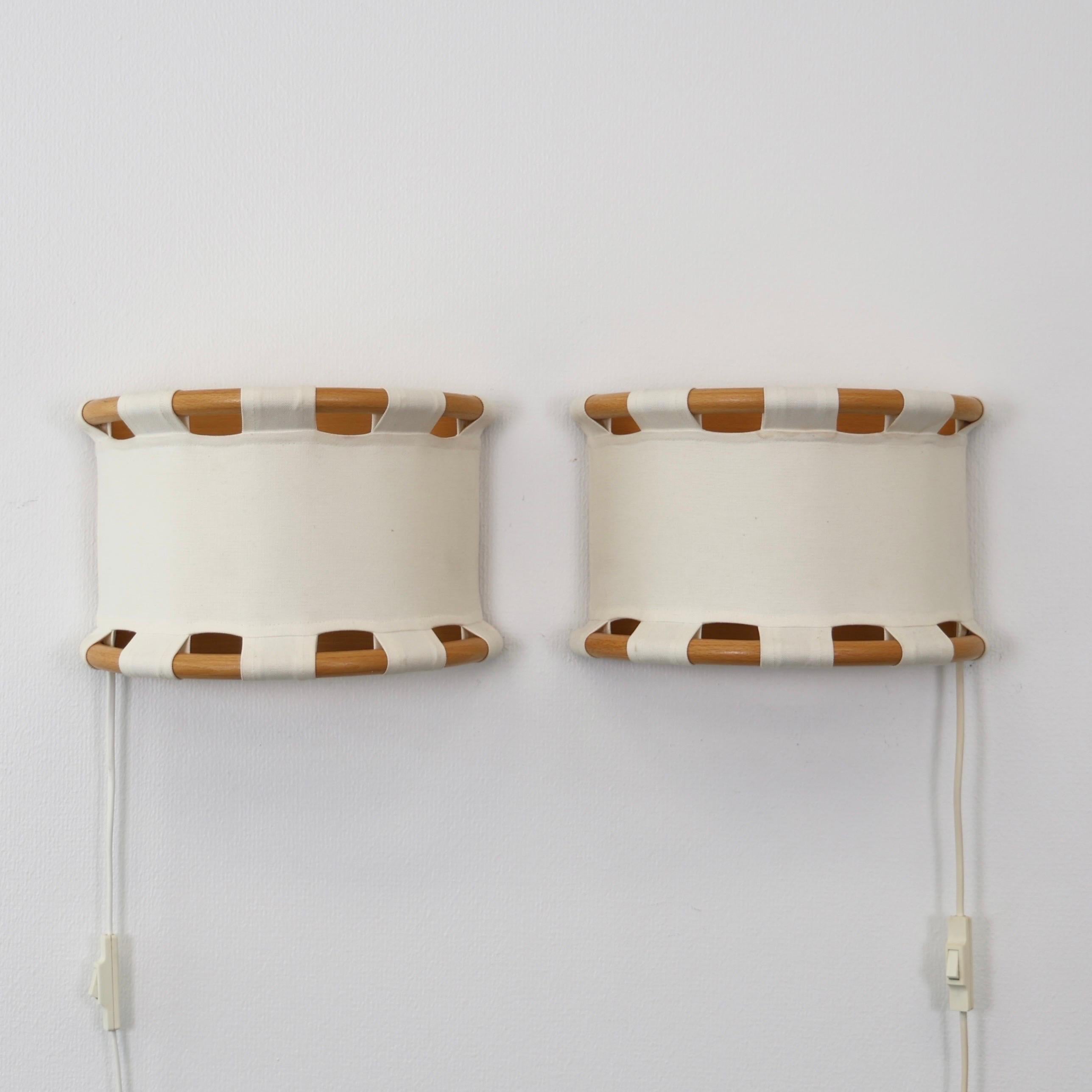 Set of Wood and Canvas Sconces designed Anna Ehrner for Ateljé Lyktan in the 1980s.

* Set (2) of half-circle sconces with wood frame and light canvas shade 
* Designer: Anna Erhner 
* Producer: Ateljé Lyktan
* Year: 1980s
* Condition: Good vintage