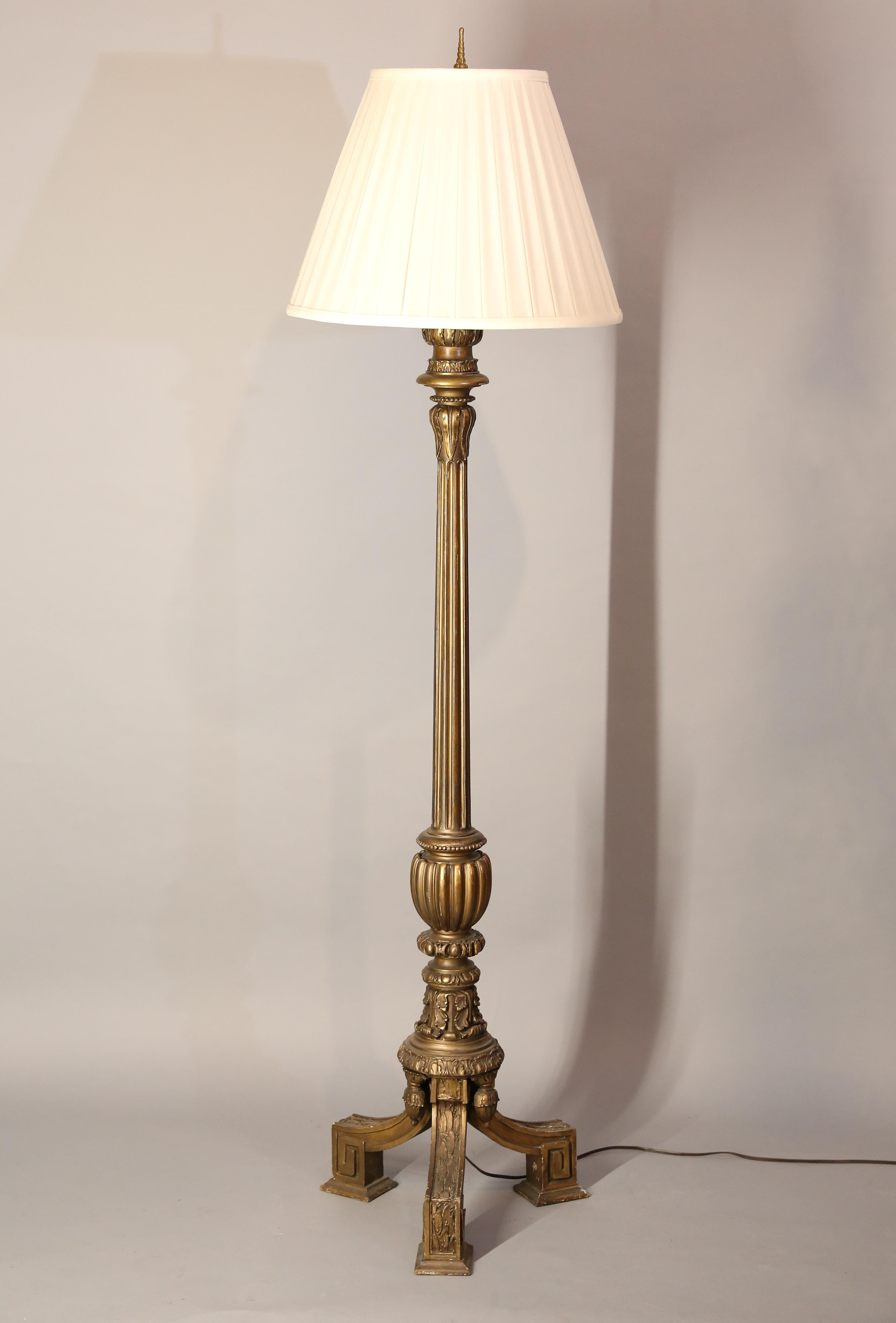 Neoclassical floor lamp is gilded to resemble bronze.
Lamp features carved acanthus leaves, and fluting and sits upon tripod base.
 