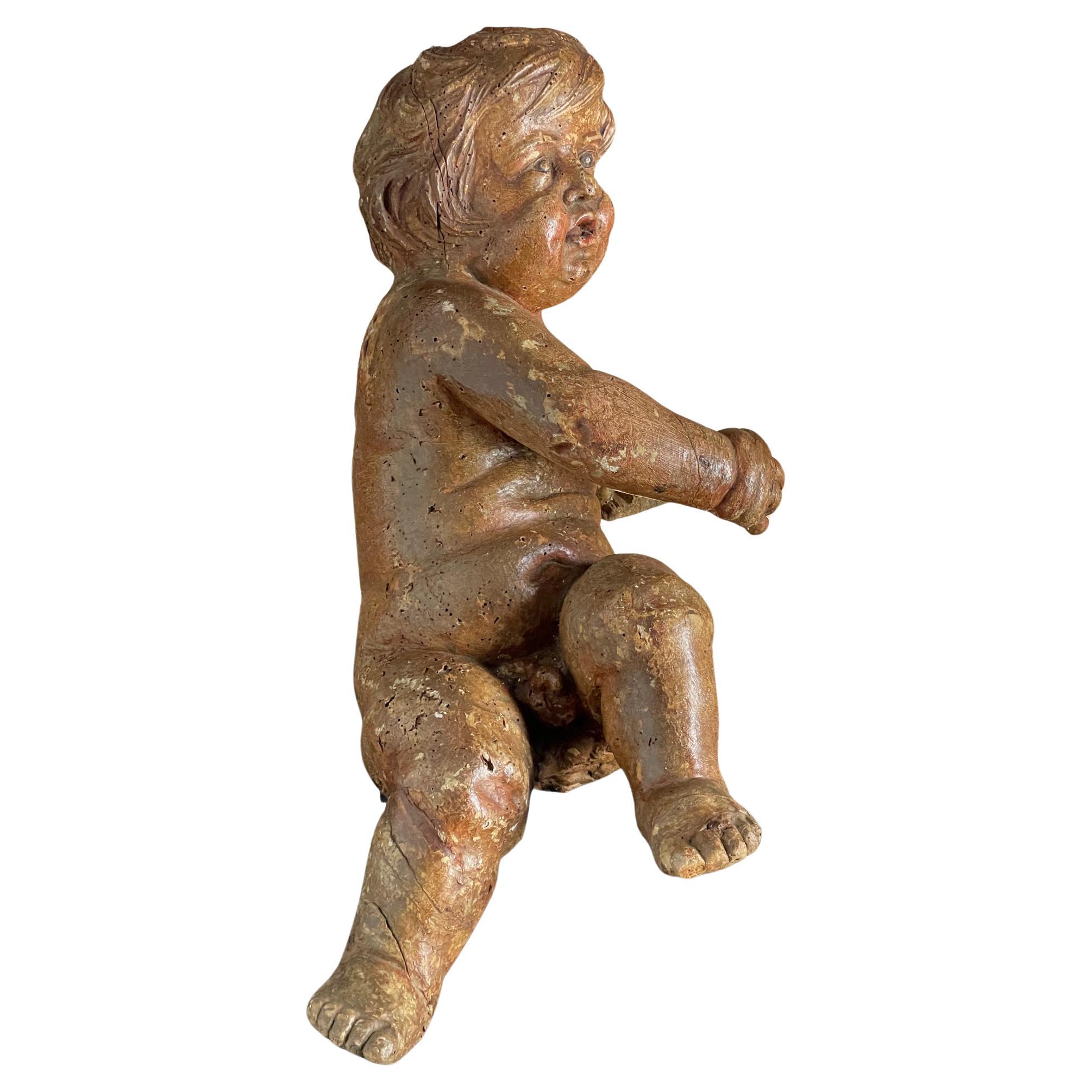 Wood carving of a putti Circa 1650 For Sale