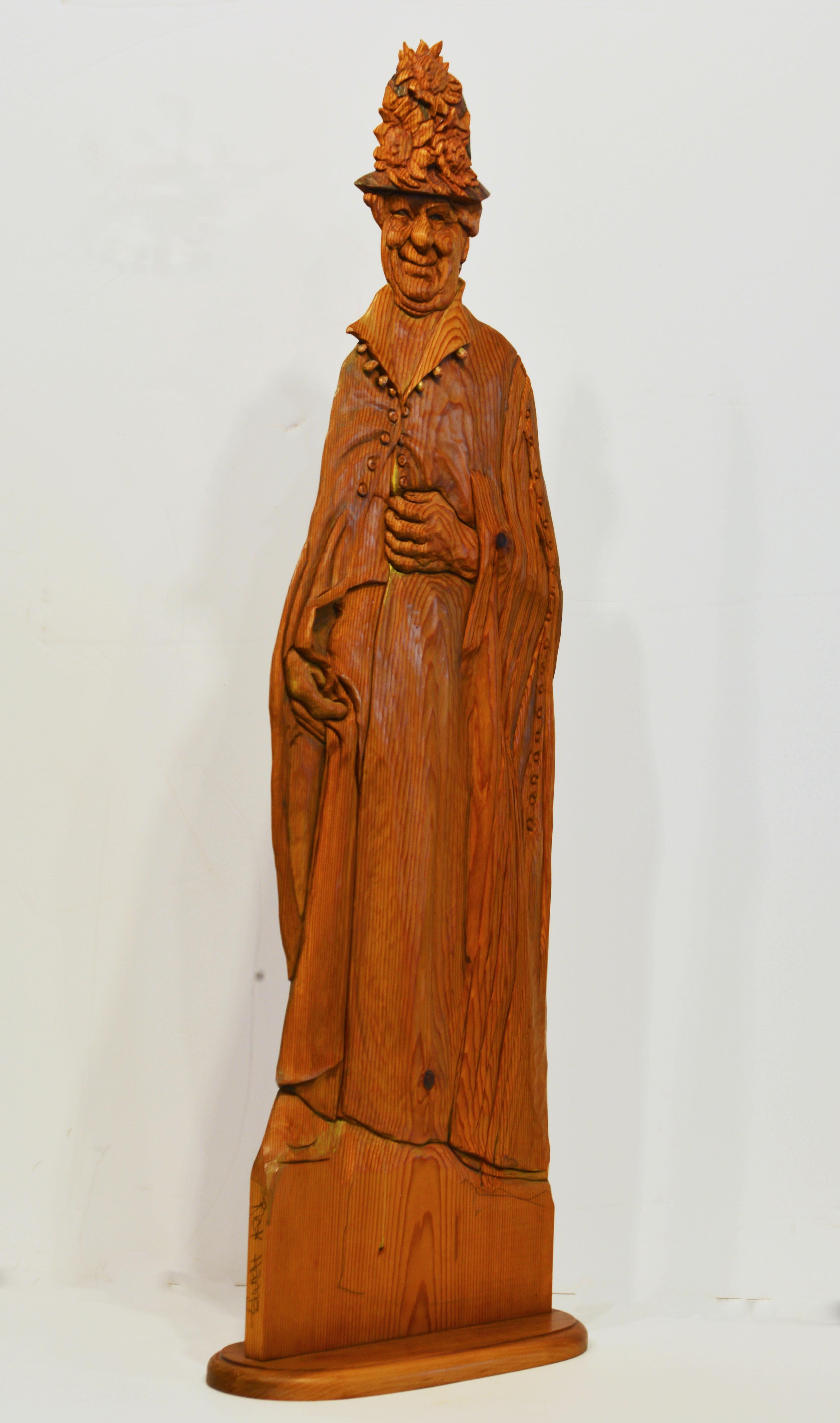 Standing 37 inches tall this carving by Rick Harney of Normal Illinois represents an older friendly lady wearing garments of the early 20th century. The name Grace refers to a similar carving of the same person. The finely carved details and the