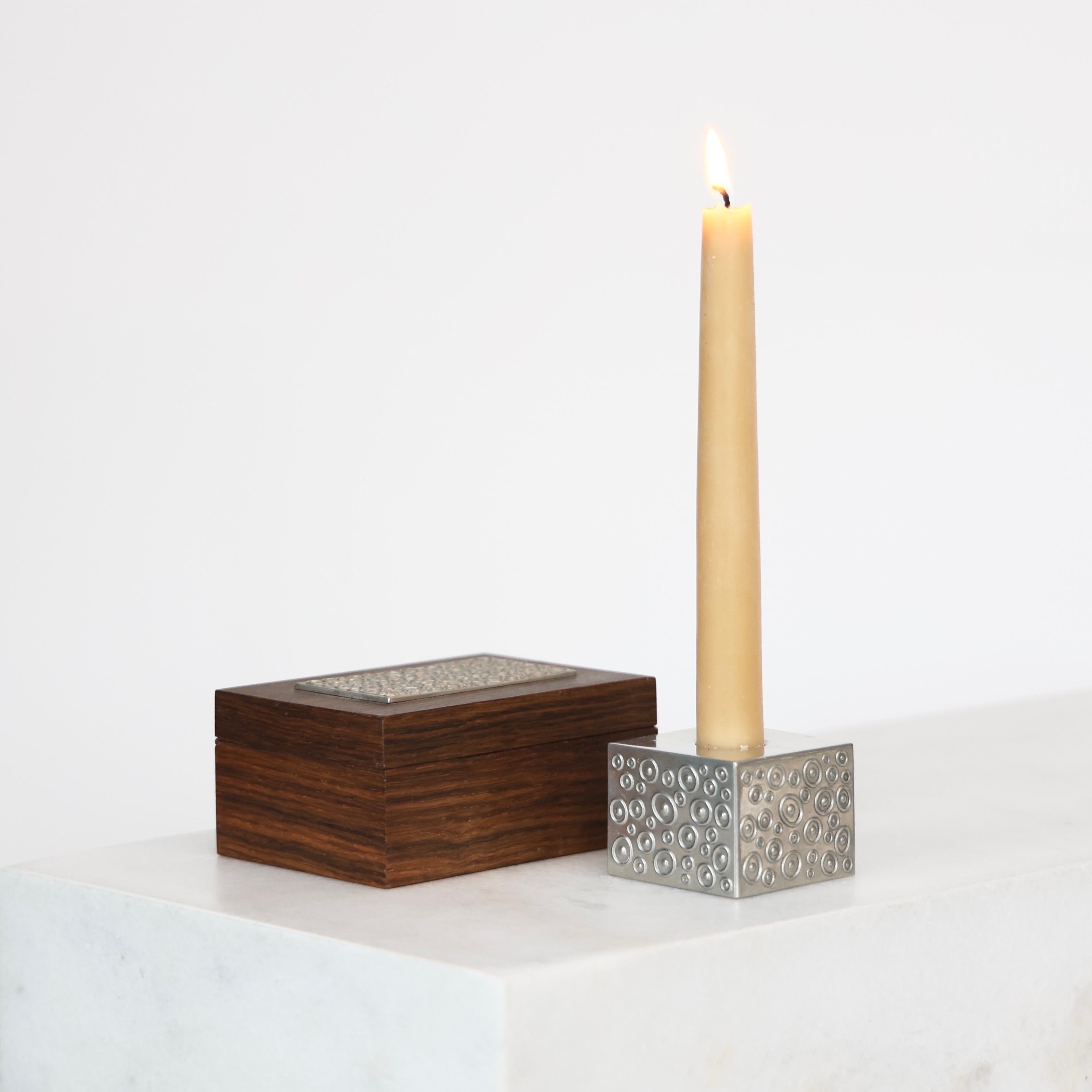 Wood Casket and matching Cubic Pewter Candlestick Holder made by Just Andersen in the 1950s. An elegant duo for a beautiful place.

* A lidded box in wood with pewter top and matching cubic pewter candlestick holder 
* Manufacturer: Just Andersen
*