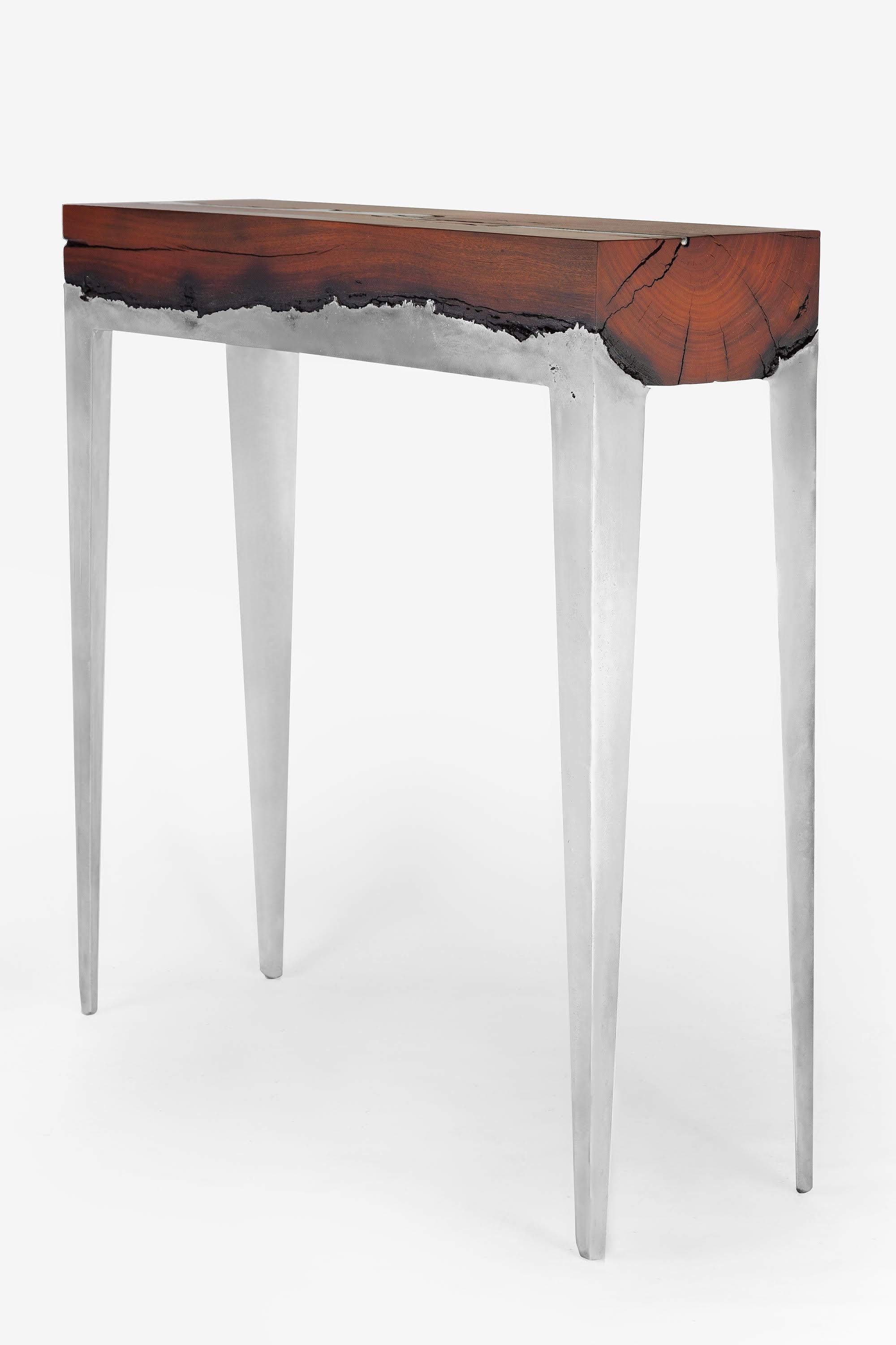 Console by Hilla Shamia. 
Eucalyptus and aluminium

Measure: 100 cm high, 100 cm length, 30 cm width
(39.3 in high, 39.3 in length, 11.8 in width)

Hilla Shamia first started working with this unique technology of casting metal into wood in 2012, as