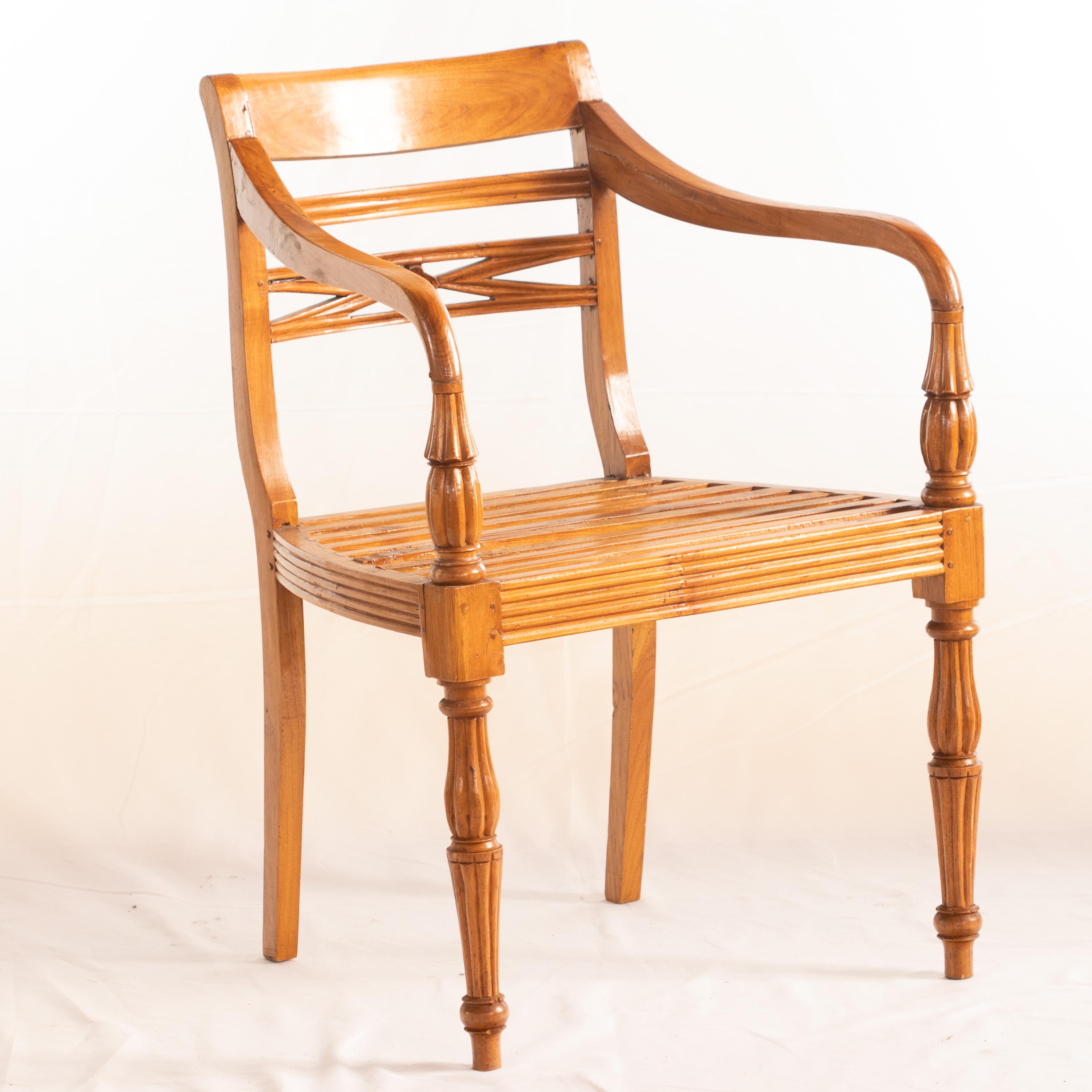 Carved solid chair for garden or home forniture. Wood chair in light brown color with a minimalist look enhanced with a vintage design. Wood furniture. New condition, never used. Comfortable furniture with a italian and innovative legs modern