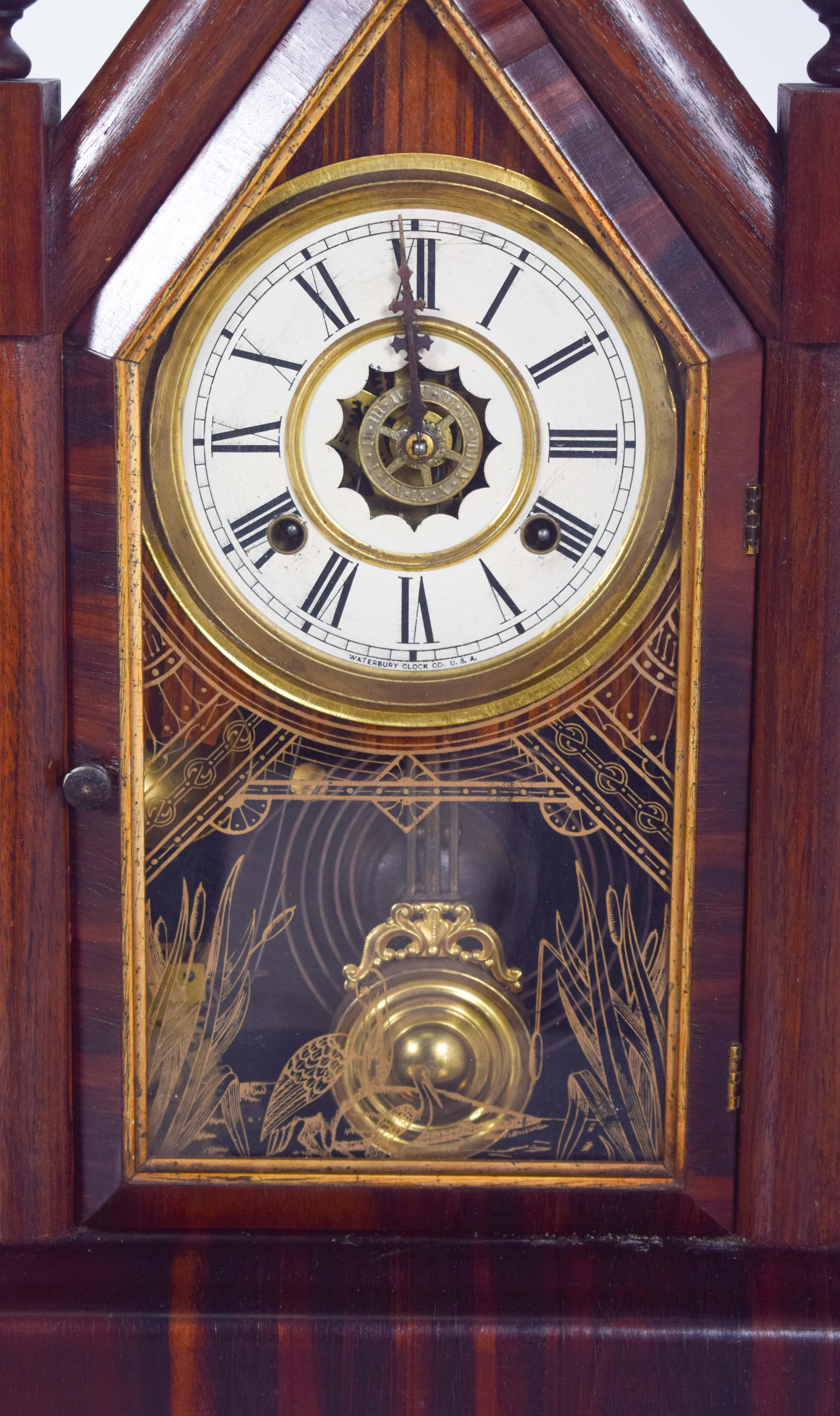 This exquisite Waterbury Clock Co. chapel clock, crafted in the USA, exemplifies the elegance and fine craftsmanship of 19th-century American timepieces. Designed in a Gothic-inspired chapel shape, the clock features a sharply pointed arch, flanked
