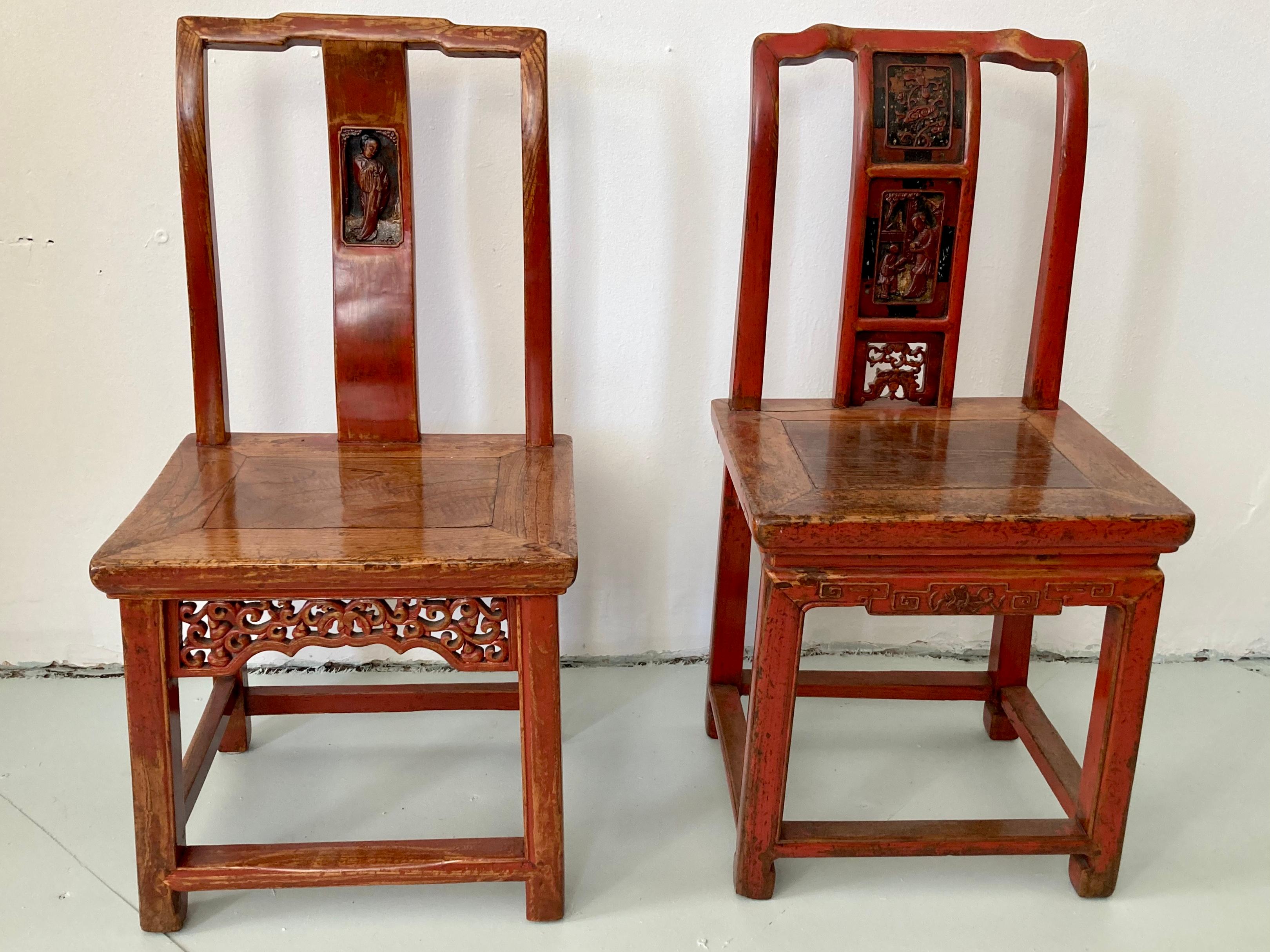 Pair of red Chinese wood side chairs. Great unique carving details on each chair. Not a true pair but are being sold as a pair and are a similar scale color and finish . Just a very fun cute pair.