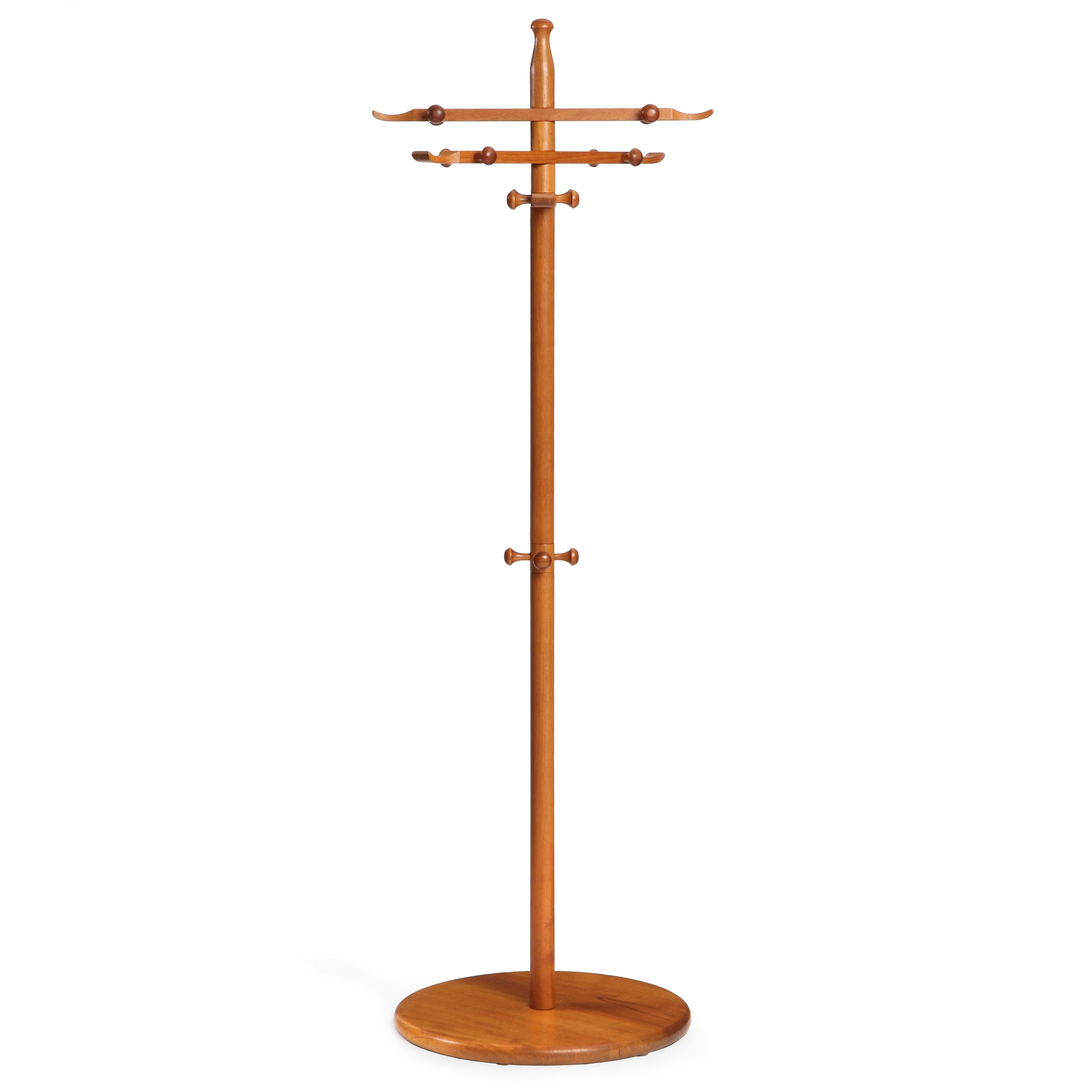 A wooden coat rack by Ebbe Gehl and Soren Nissen in solid teak; well scaled and finely crafted in teak with a disc base, vertical pole supporting three revolving arms with lathe turned hooks. Produced by Aksel Kjaersgaard in Denmark in the 1960s.