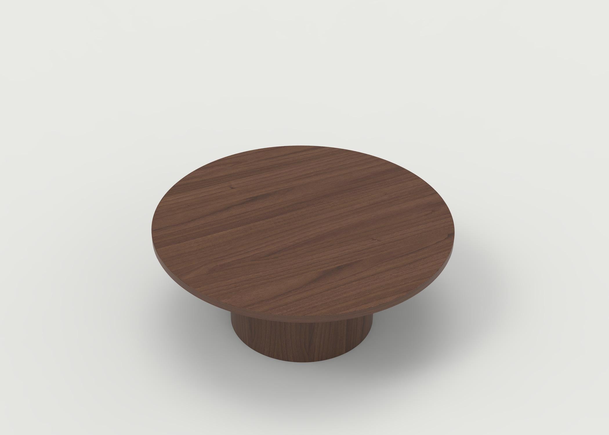 The Benson coffee table is shown with an oak wood top in natural finish with a round base and painted round posts. It can be customized in your choice of wood and finish as well as size. Price is for item shown in primary photo in all walnut
