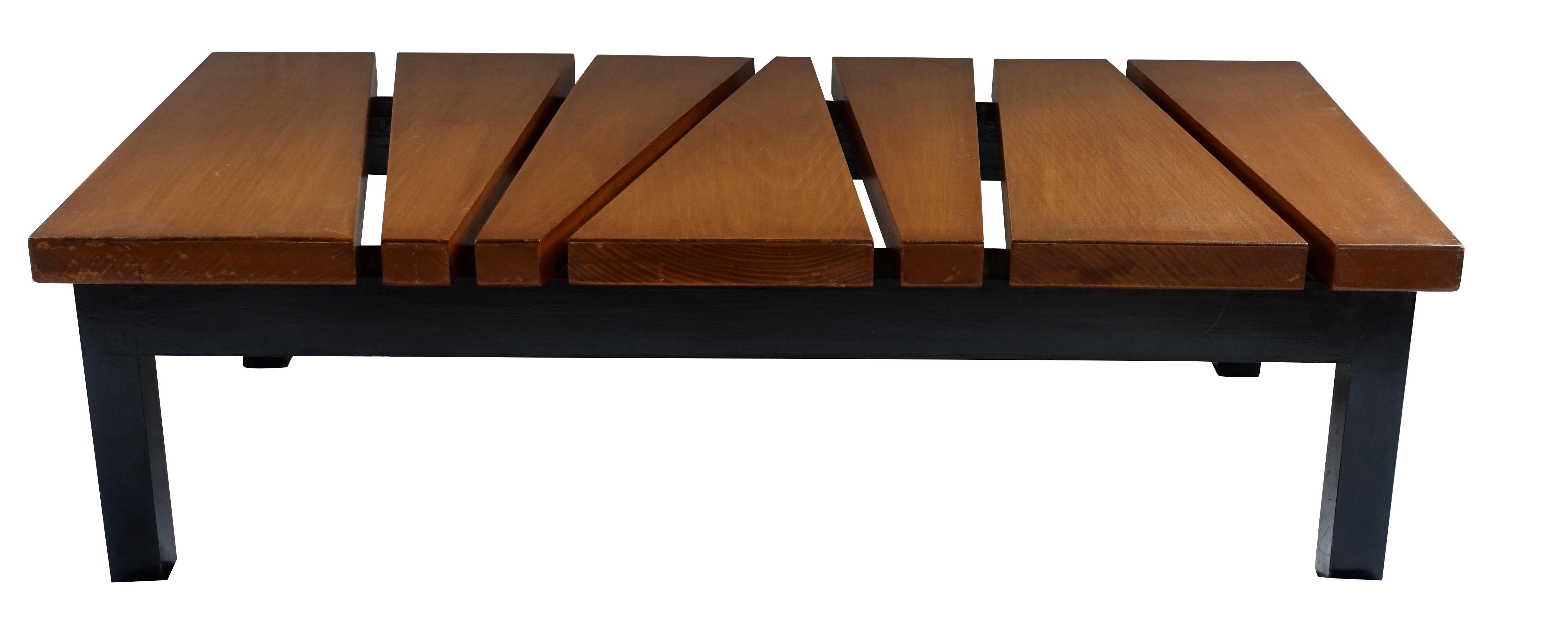 Mid-Century French coffee table with a black base and brown top.
Zig Zag top design.