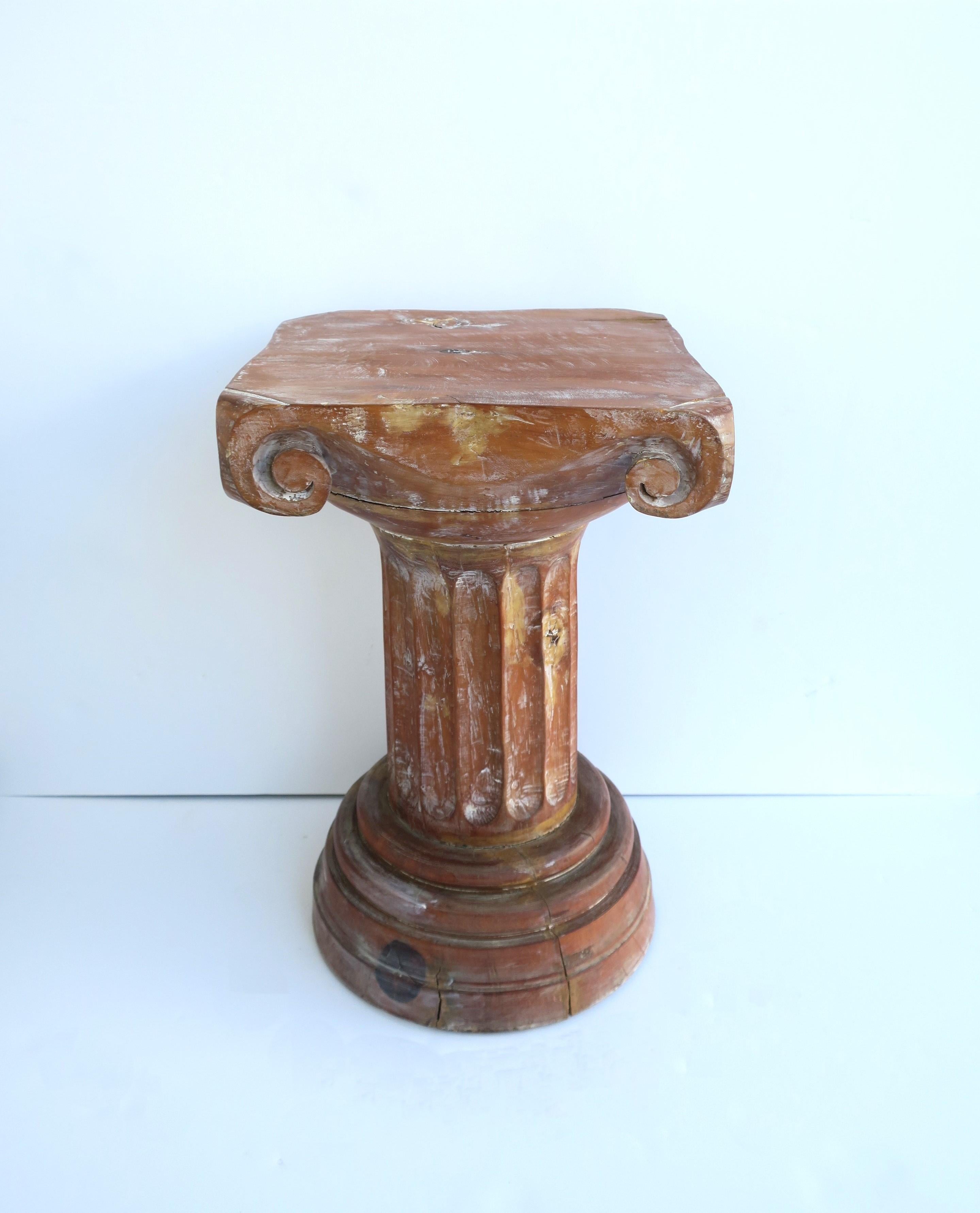 A wood 'Ionic' style column pedestal with fluted pillar and round base, in the Neoclassical Greco-Roman style, circa 20th century. Column is substantial, solid, all wood with fluted pillar center and graduated round base; great as a side/drinks