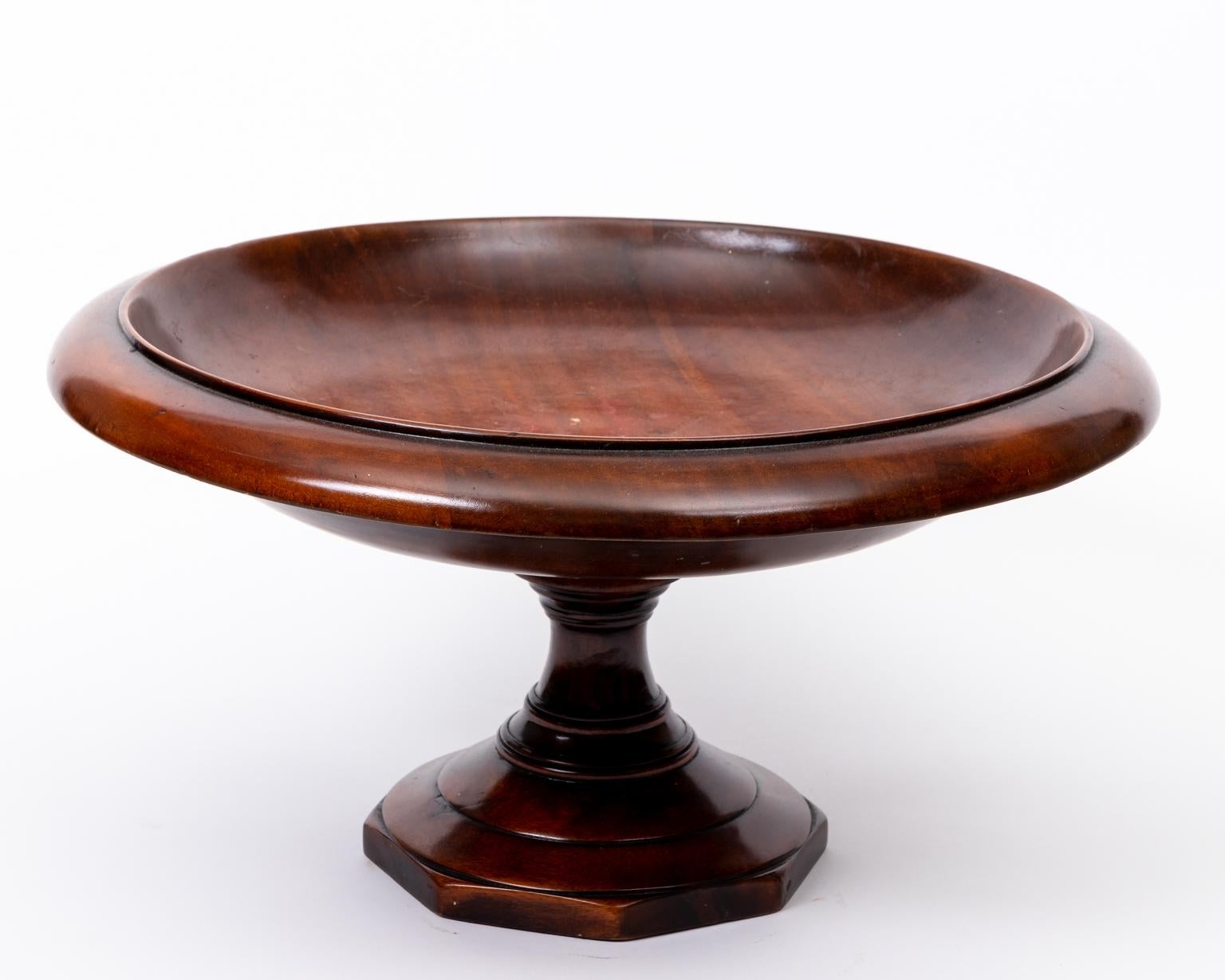 Carved decorative solid wood compote bowl constructed on a single pedestal and an octagonal shaped base. Please note of wear consistent with age including minor finish loss, surface scratches, and patina as seen at the basin of the compote bowl and