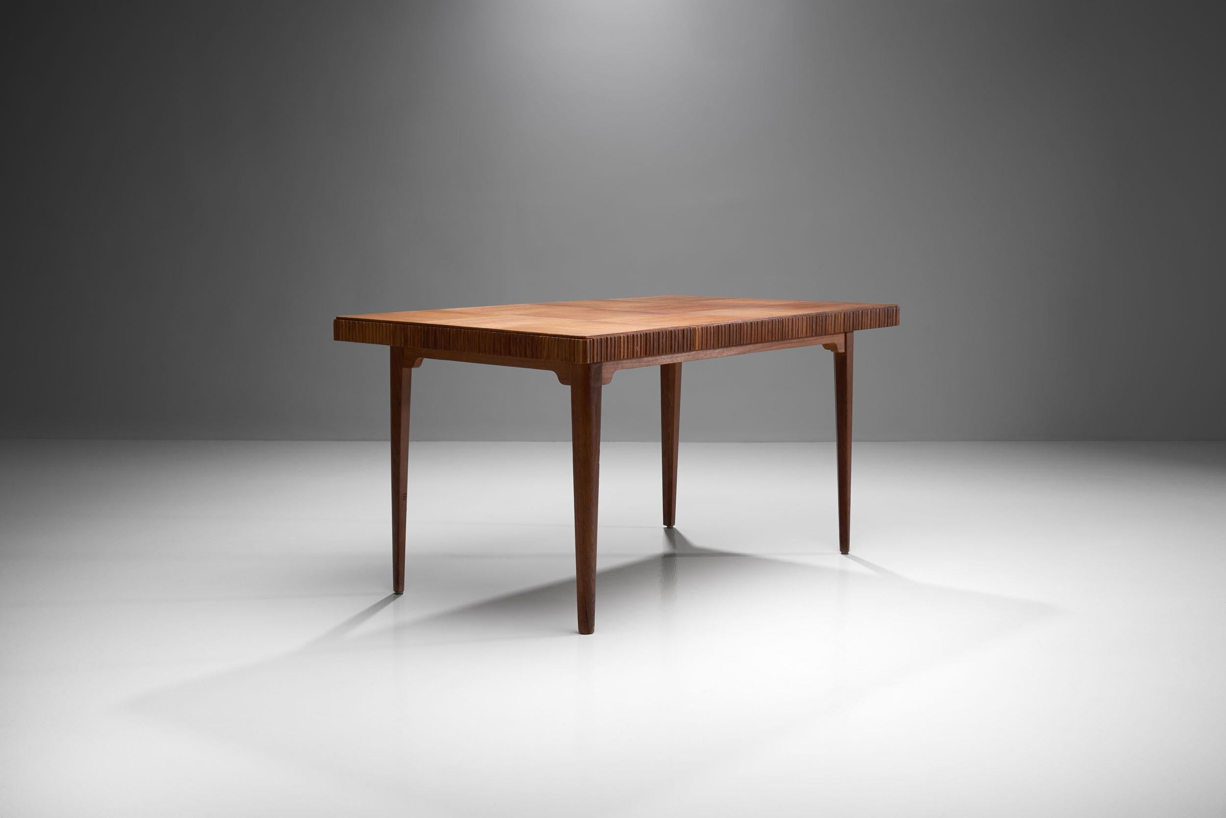 An exquisitely crafted Scandinavian Modern table. Made out of wood in cognac brown tones. This table has a thick top with a beautiful pattern that plays with vertical and horizontal lines creating a mosaic effect. The thick edge of the cover is