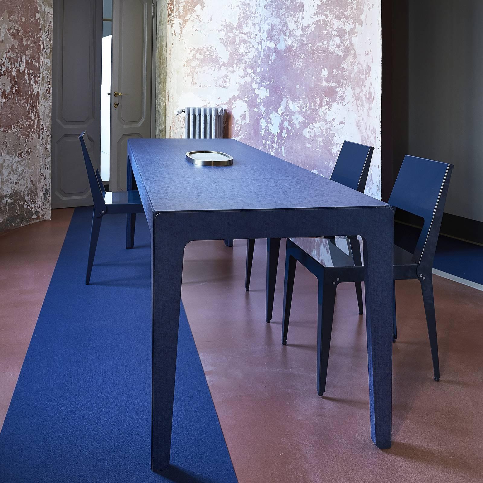 Introduced at the Fuorisalone event during 2018 Milan Design Week, this table is made of MDF with blue-stained eucalyptus veneer and has a sleek silhouette that recalls the proportions of the iconic Italian 