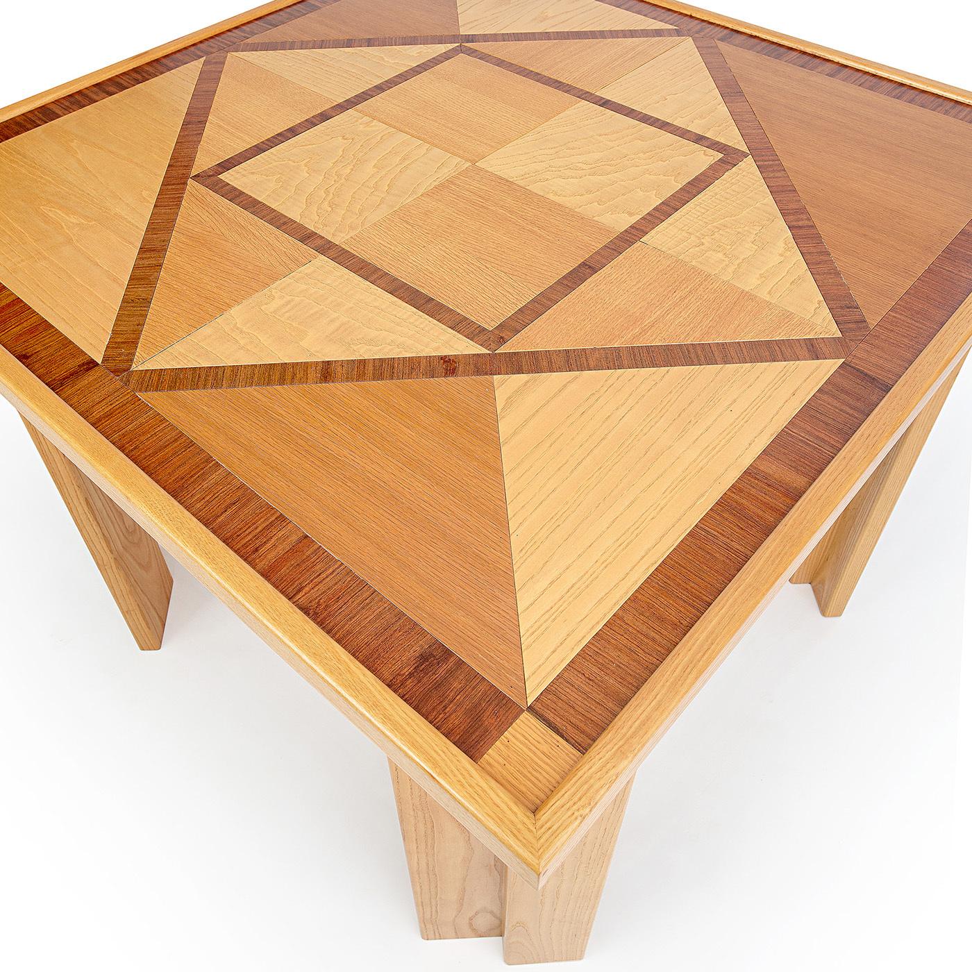 This distinctive dining table is entirely handcrafted using traditional woodworking techniques, boasting an exquisite geometric square inlay top embellished by decorative sections of oak-, rosewood-, and ash-veneered wood. A striking feature of this