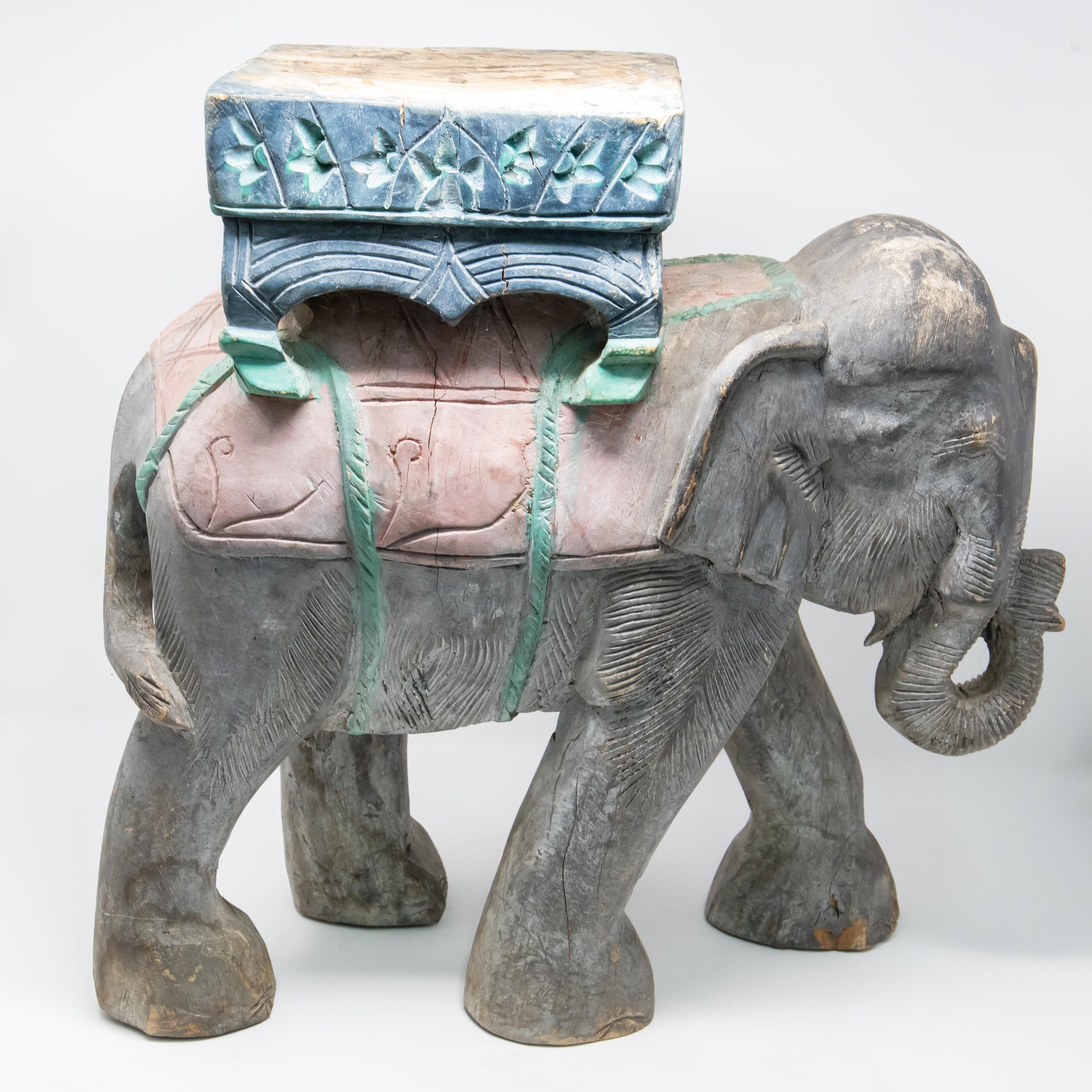 Offering a beautiful elephant plant stand. Hand carved and hand painted the detail is amazing. Elephant is mid stride with his trunk bowed up. Stands strong for a beautiful urn or planter to sit atop this piece.