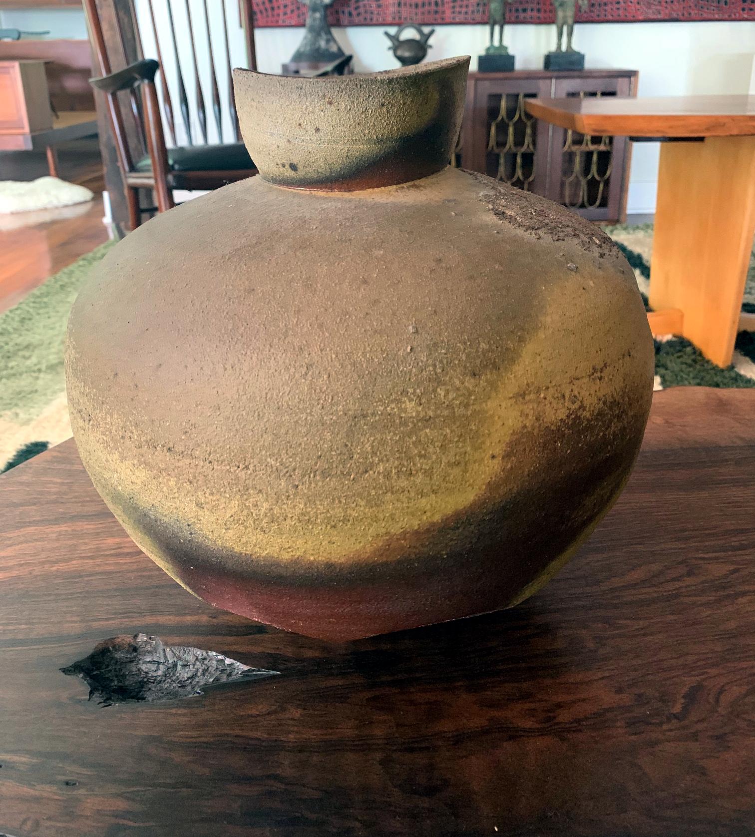 A large stoneware jar by Paul Chaleff (1947-) made in 1987 and was purchased directly from the artist's studio in New York. Wood fired ceramic vessel with handcut lower body and pronounced surface firing marks and ash glaze. It is marked with the