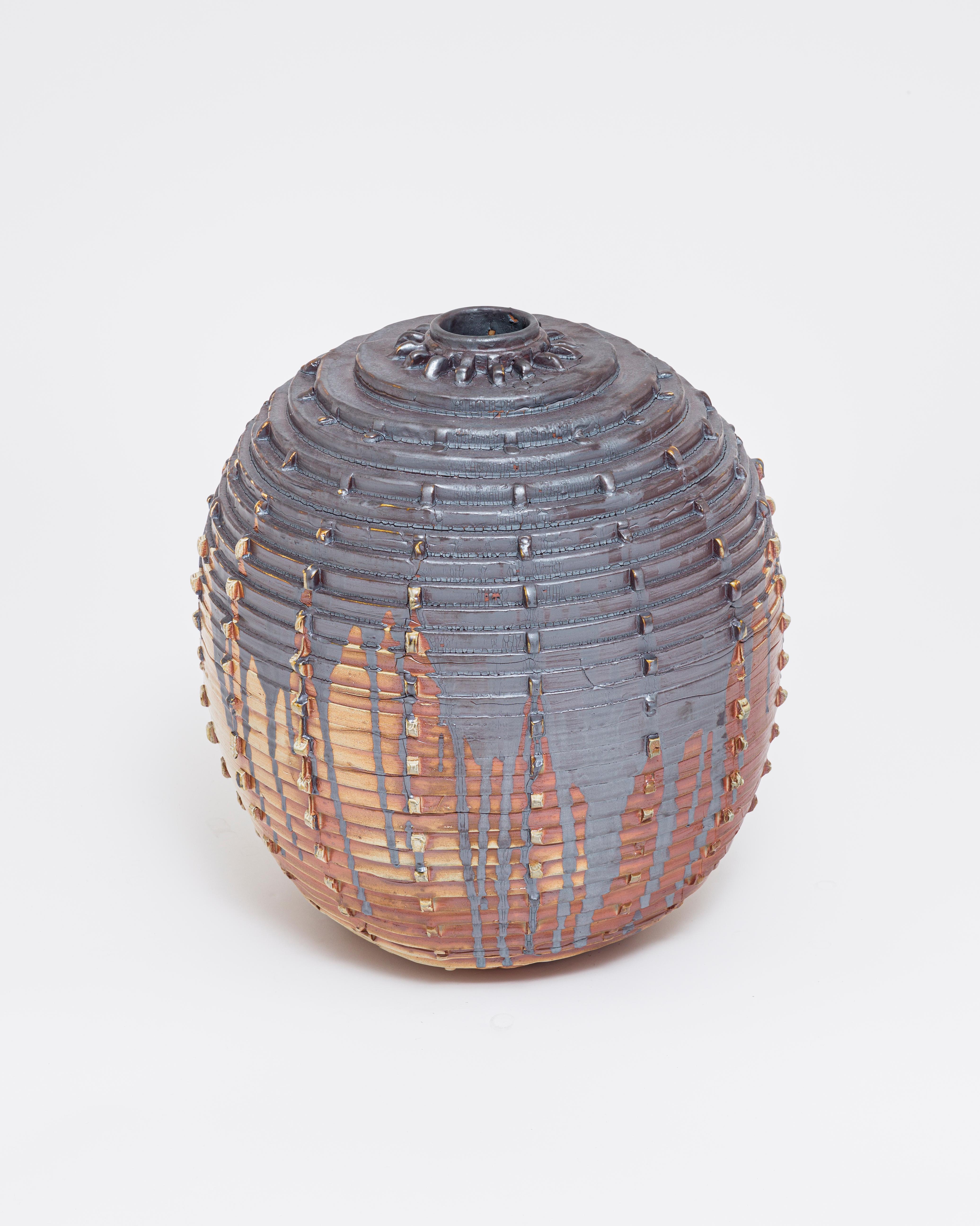 A large-scale decorative and functional (it can hold water) vase. The color comes from a splash of dark brown, almost metallic glaze and the natural wood-fired process. An extremely interesting and sculptural shape. 

About Ellen Pong
Originally