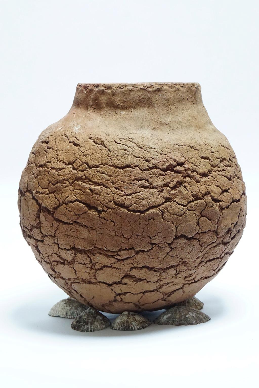 This is a completely handmade vase by artist Joaquin Reyes from the Canary Islands (Spain). He does not use any moulds or wheels; he moulds local volcanic clay with his own hands and put it in a wood kiln. Mr. Reyes started with Primitive Canarian