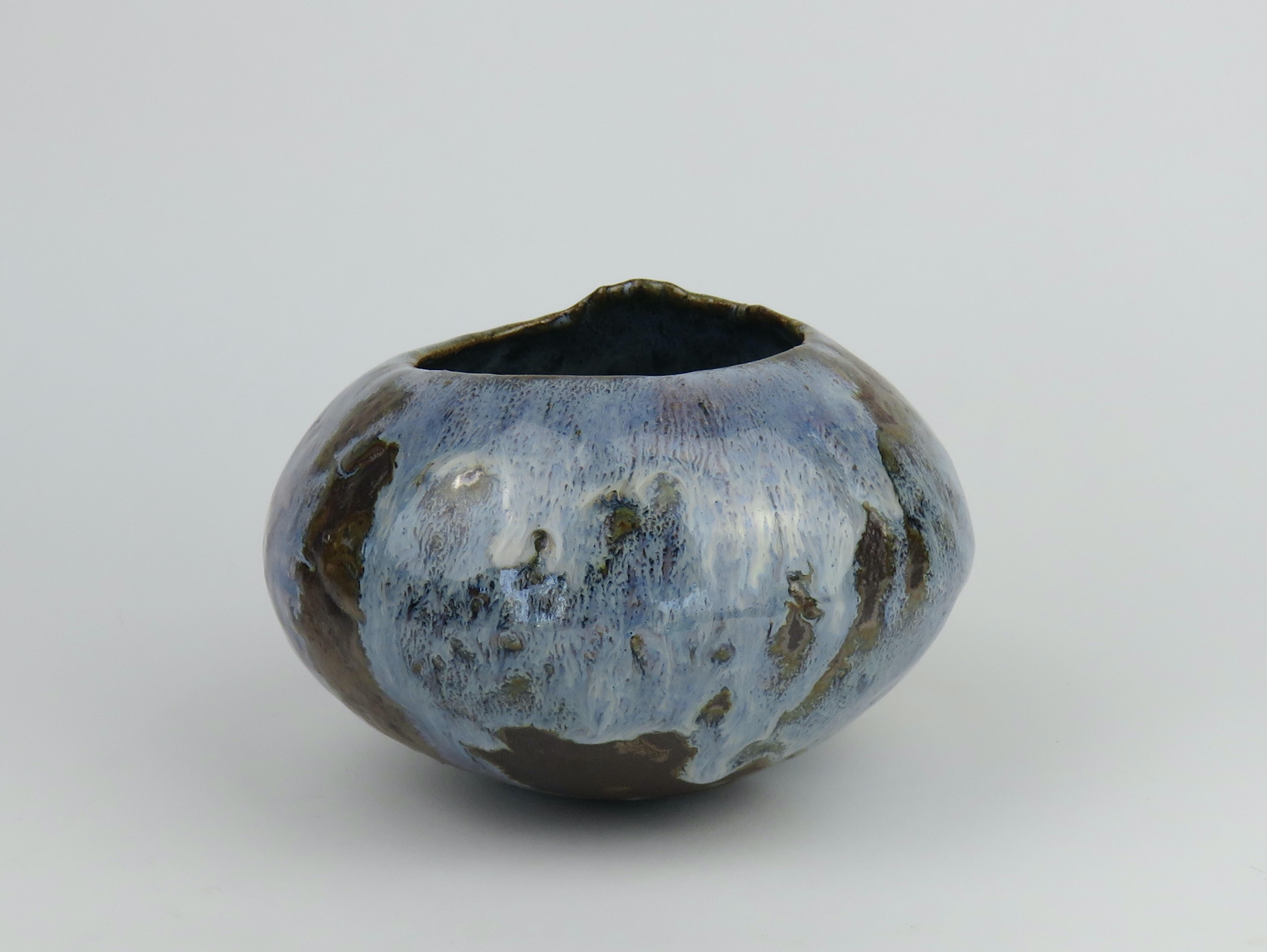 Wood-fired, hand-coiled ceramic bowl with blue glaze.
When a handmade clay pot is fired in a wood-fired kiln, the results are always an unpredictable surprise. This one surpasses all expectation. While the blue glaze melted and dripped 'just so',