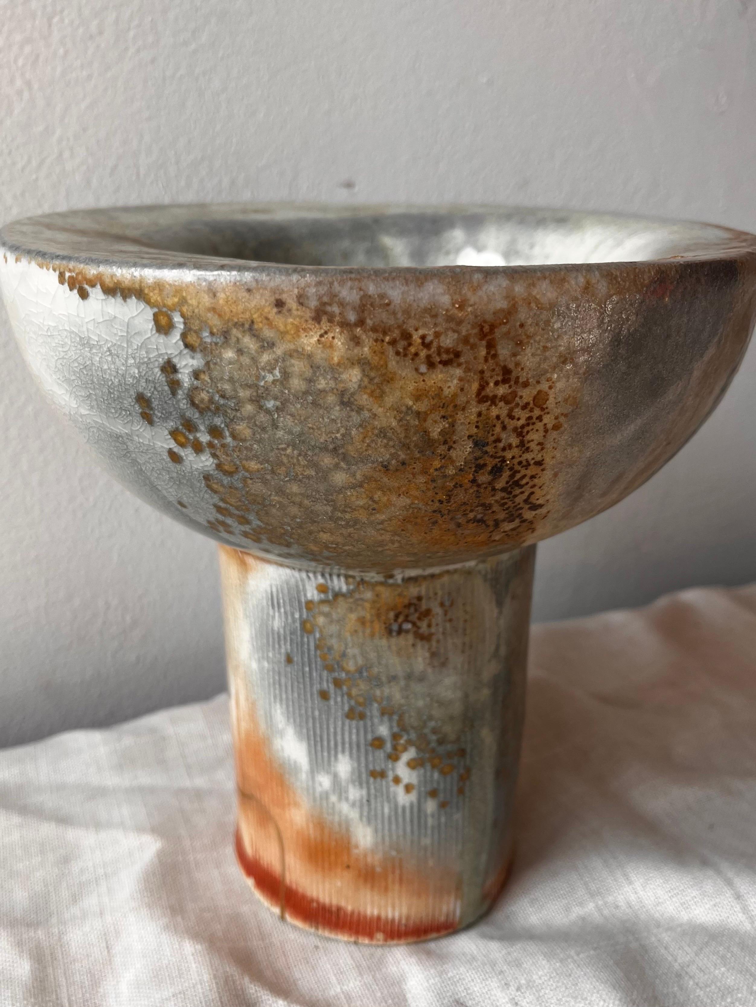 Hand-built porcelain pedestal bowl, wood-fired in a traditional anagama noborigama Japanese kiln in upstate New York. Shino glaze in blue and bronze tones with crystallization from wood-ash.  22 karat gold kintsugi repair on the base of the foot. 