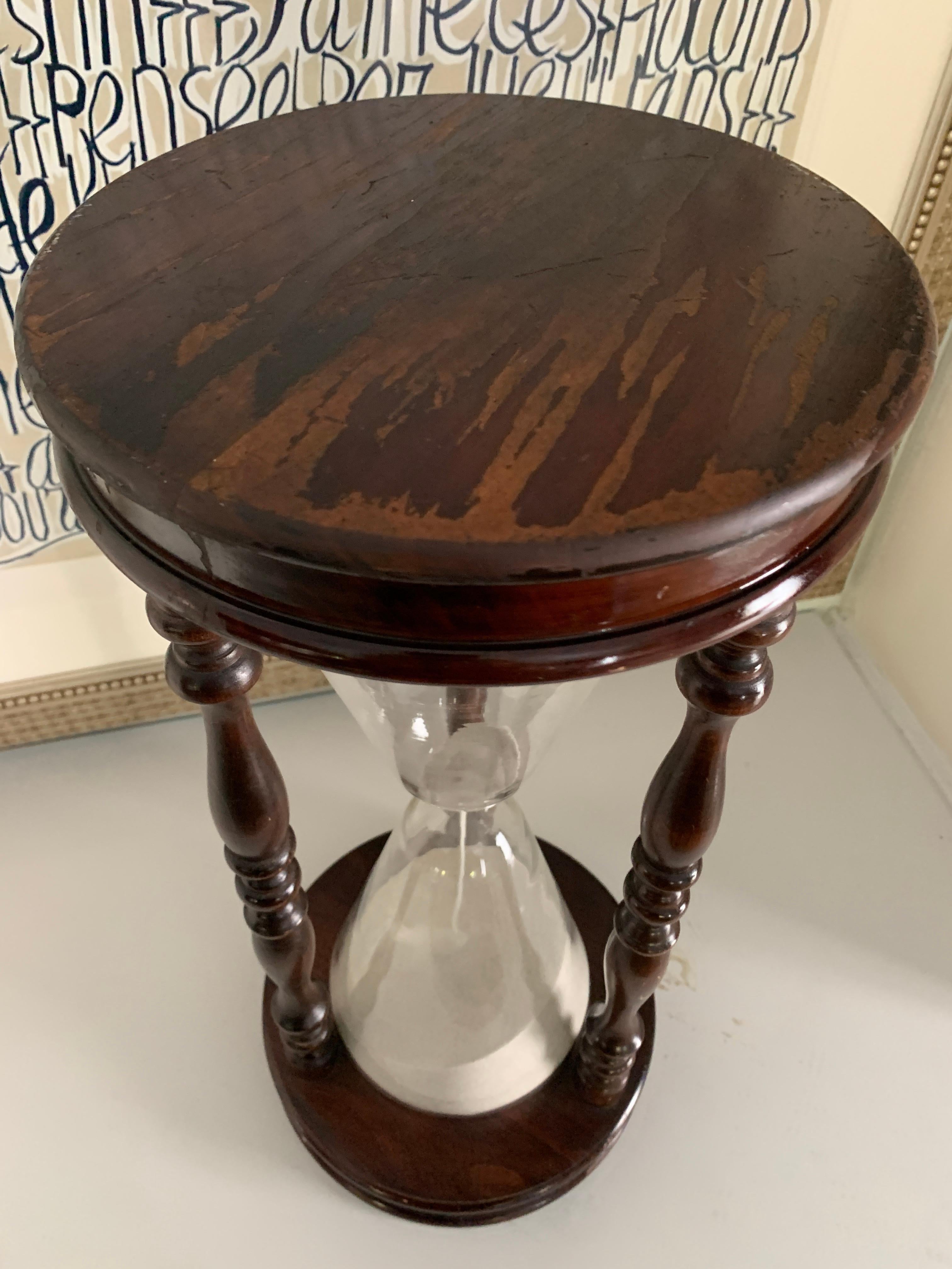 Over 20 inches tall, a wonderful wood framed hour glass or sand timer. A compliment to the library, console table, shelves or as a bookend - a great piece that will stand out in time. The top and bottom surfaces have areas of distressed wood, we
