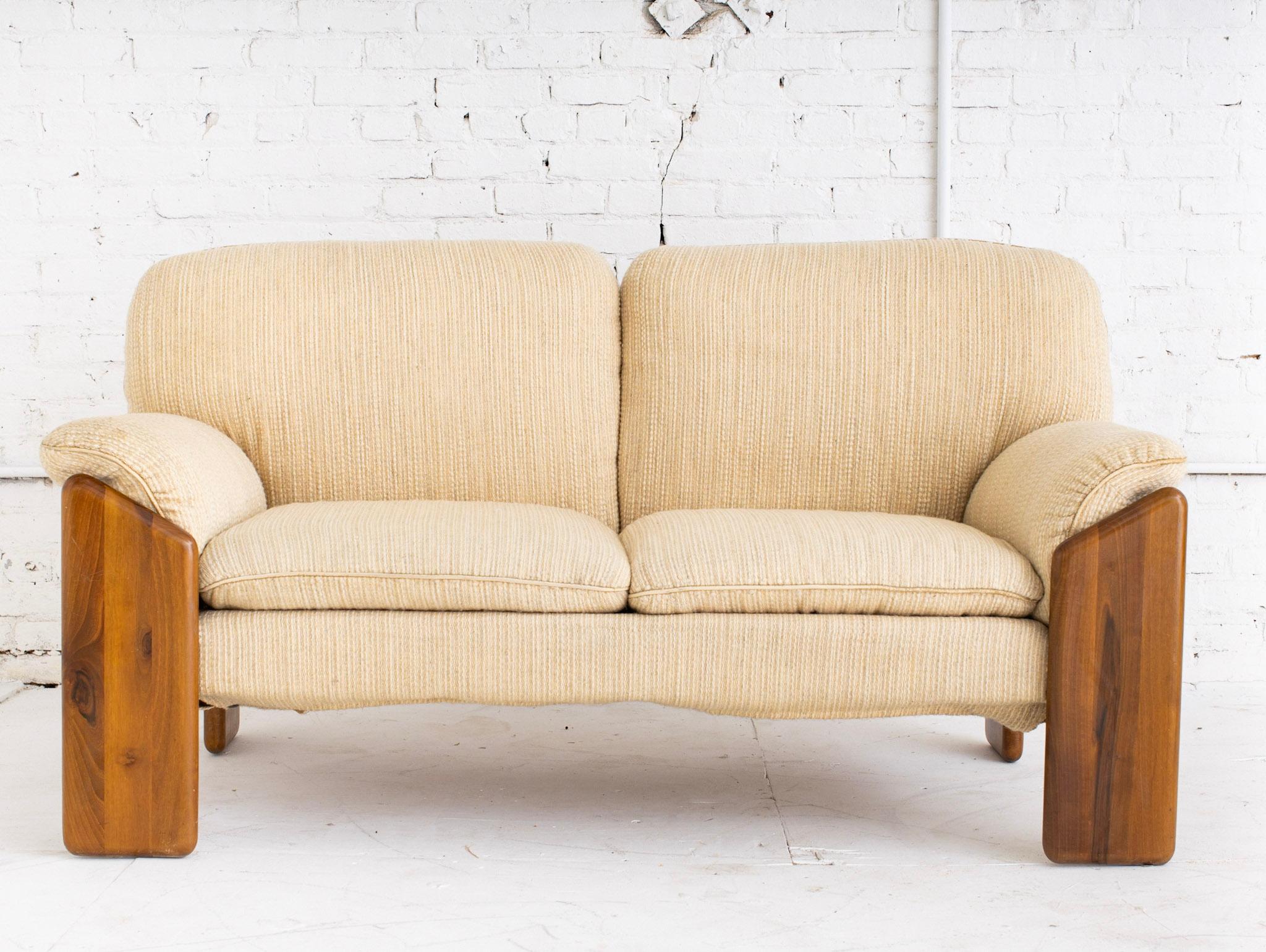 Solid wood frame sofa by Mario Marenco (1933 - 2019) for Mobil Girgi. Original textured beige wool upholstery.

Born in Foggia, Italy, Marenco fostered successful careers in both comedy and design. Marenco studied architecture in Naples and soon