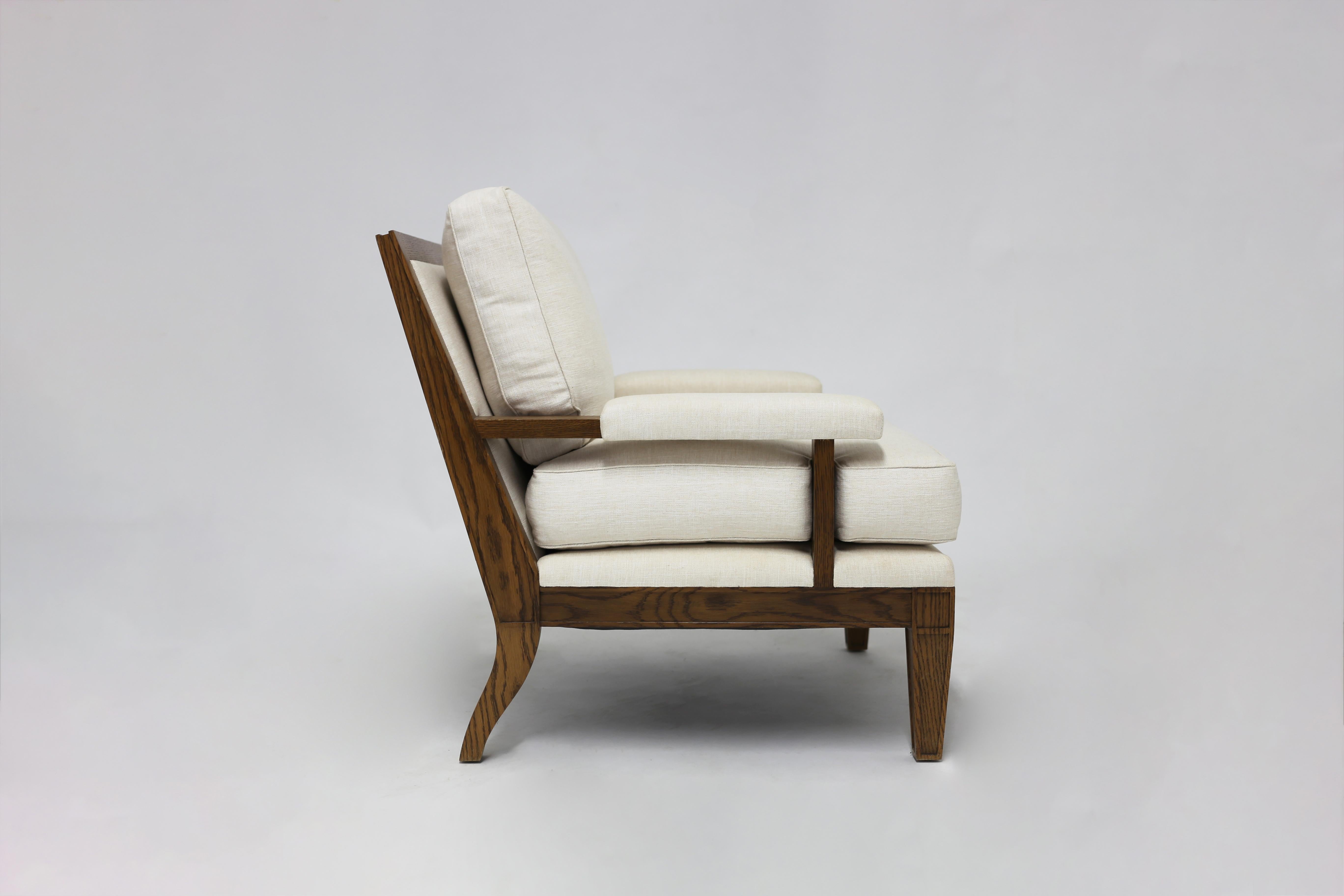 The Viva club chair is a beautifully styled and comfortable armchair shown with linen cushions and arm pads - all hand sewn cushions with feather and down inserts with carved wood frame and legs with inset panels and arm stretchers adding an elegant