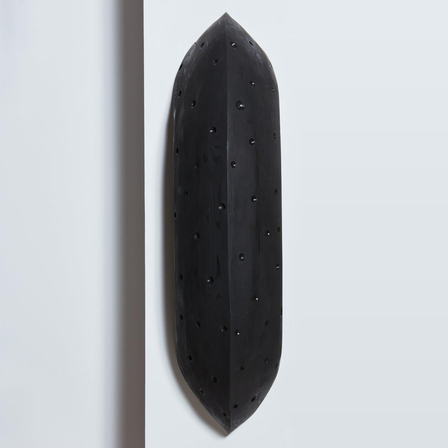 An oversized abstract wall sculpture by Canadian artist Erin Vincent. This piece was constructed with stained black natural wood and features carved dots throughout giving it a beautiful textural appeal. 

Erin Vincent is a Canadian artist who