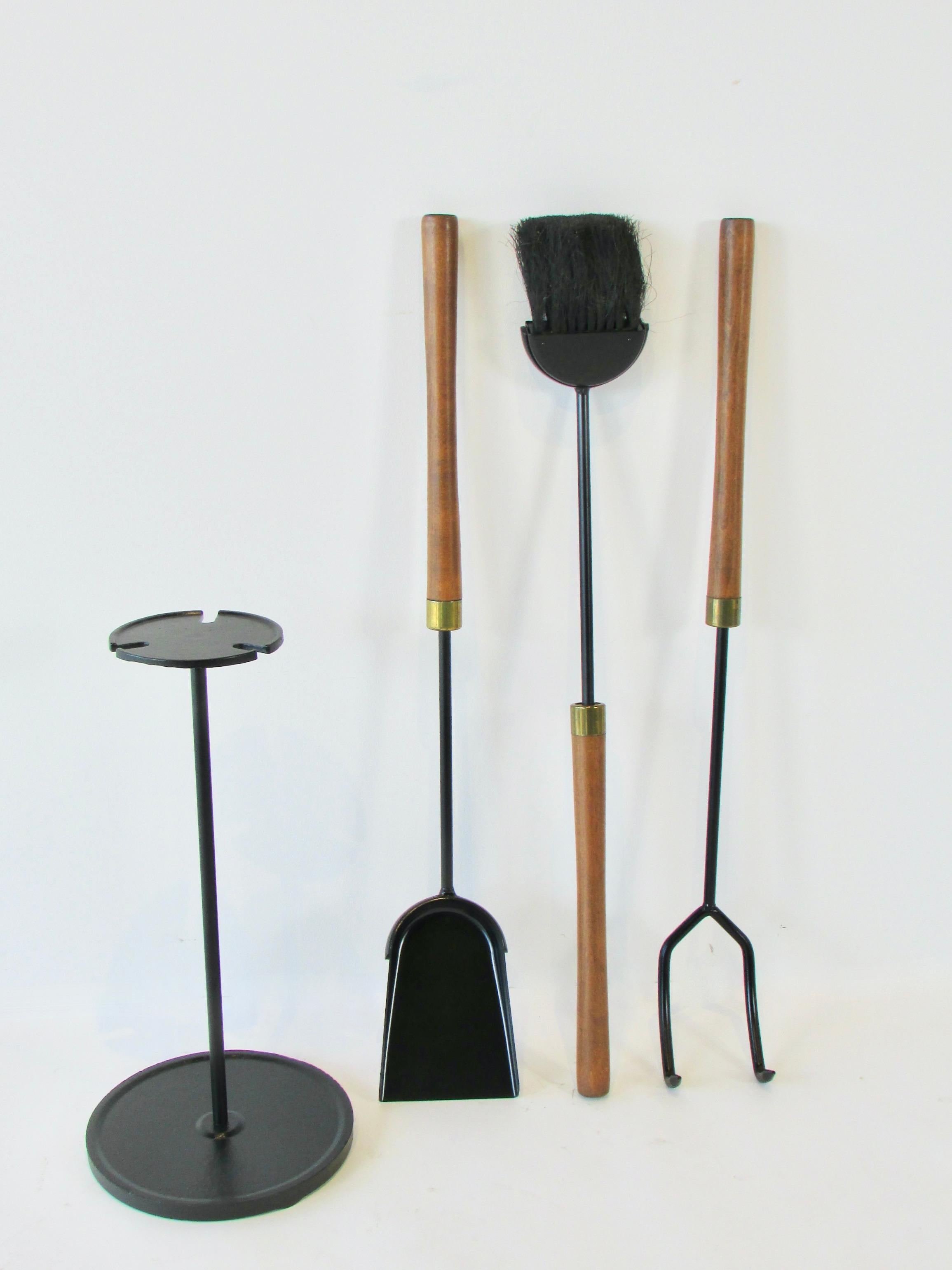 Three wood handle fire tools in circular stand. Manufactured by Seymour co. Base measures 17 tall with 9 diameter.