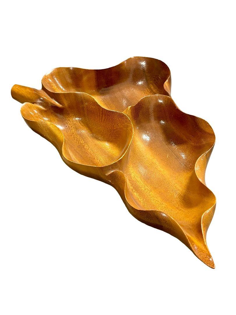 Original Mid-century carved wood Leaf-shaped divided serving dish bowl. Its intricate leaf design exudes classic elegance. Perfect for use or display, this timeless piece adds modern charm to any space.

Dimensions: Height: 3