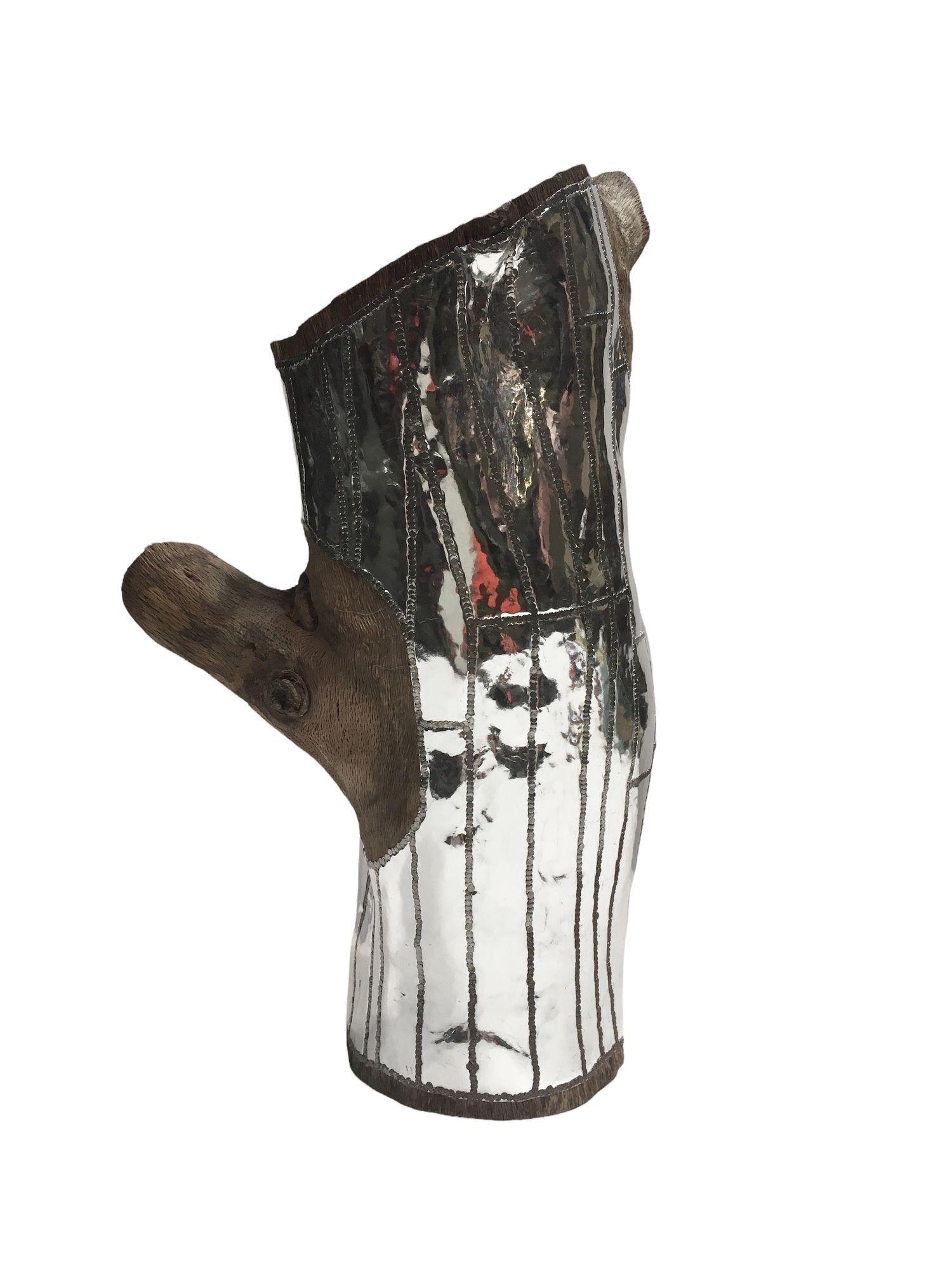 Wood Log Urban Sculpture in Oaxacan Silversmith Style by artist Blake Shane. $1,750
 
This Urban Sculpture consists of a wood log that has been covered with a reporpused metal sheet then obsessivily hammered by hand by artist Blake Shane of los