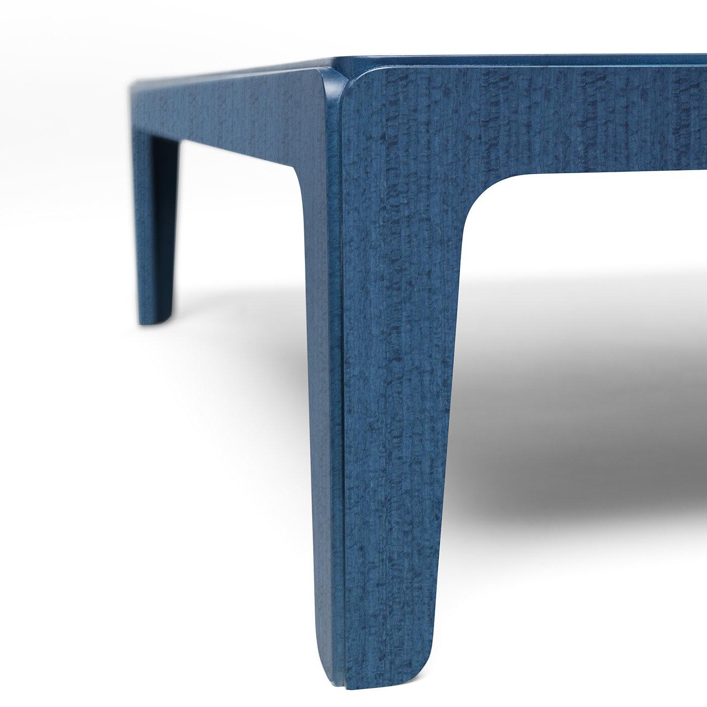 Reinterpreting the look of stately, antique tables with a contemporary flair, this low coffee table is made of MDF with a stunning blue stained eucalyptus veneer. The solid-block, sculptural appearance is in fact the result of a skilled assembly of