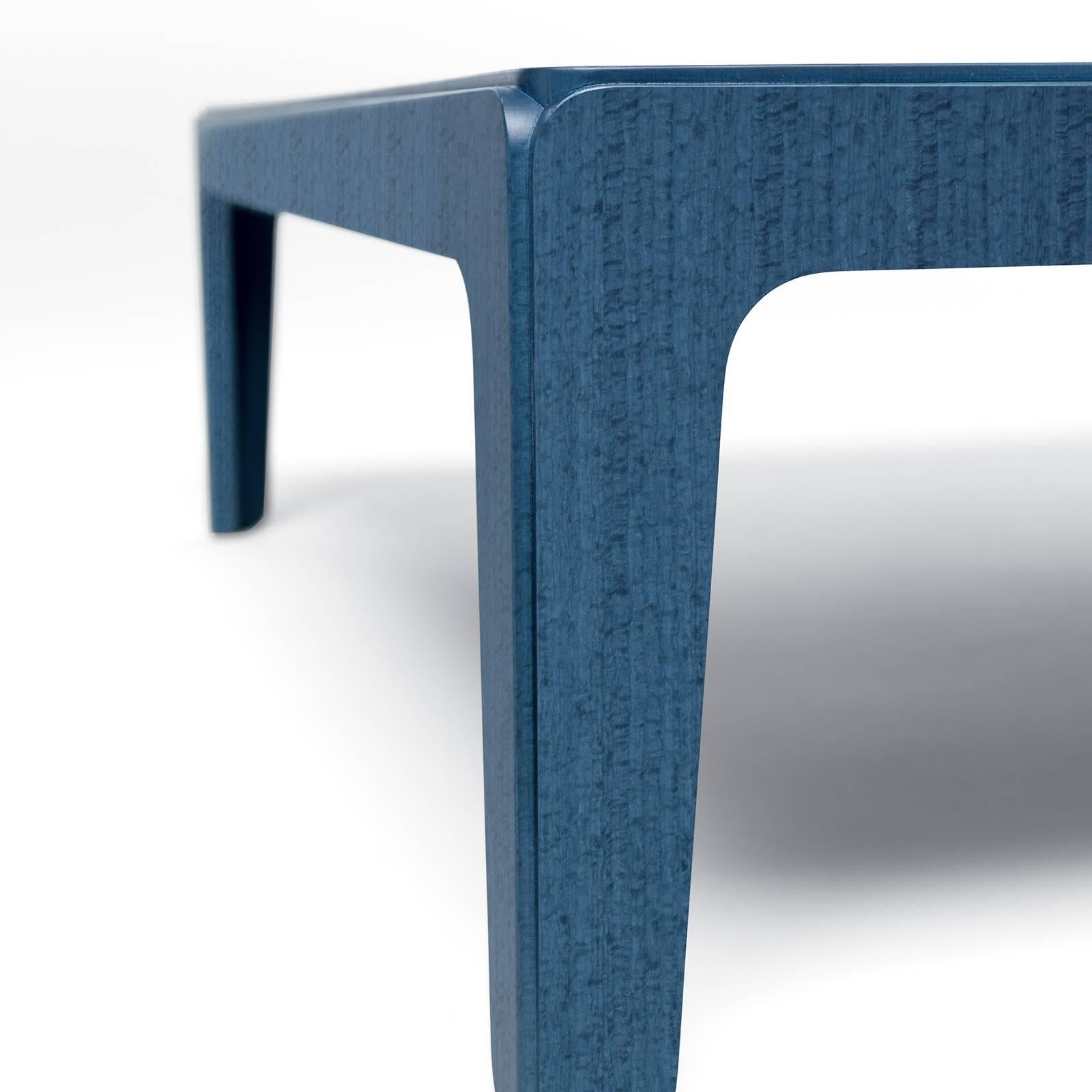Ideal as a bedside table or next to a sofa for resting books or drinks, this side table is also a modern and stylish accent piece to display in an entryway or office. The geometric square frame is crafted of MDF finished with blue-stained eucalyptus