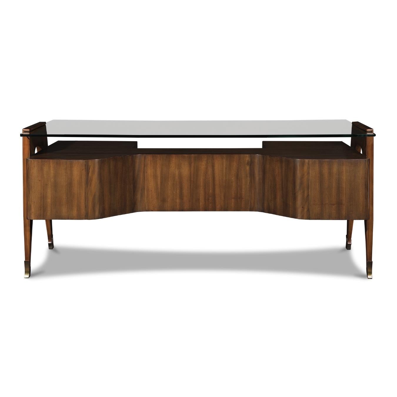 This desk was inspired by the Mid-Century Modern style. It is made from Koa wood and has four drawers with wooden handles. Adorned with brass detailing and a floating clear tabletop under which you can exhibit books or other decorative items. The