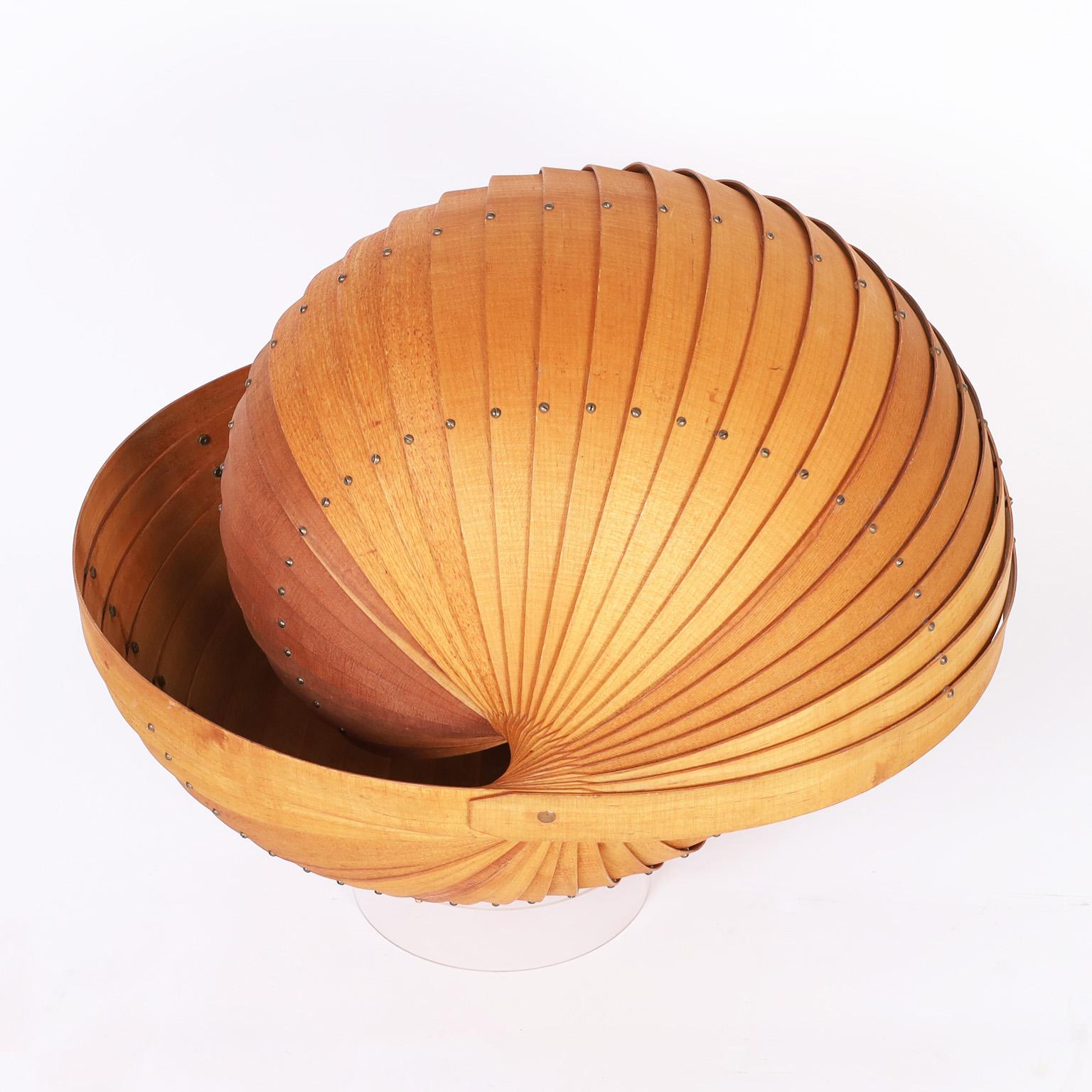 Mid century sculpture crafted in oak and ash woods with striking precision creating a mind blowing double sided nautilus seashell. Presented on a lucite base.
