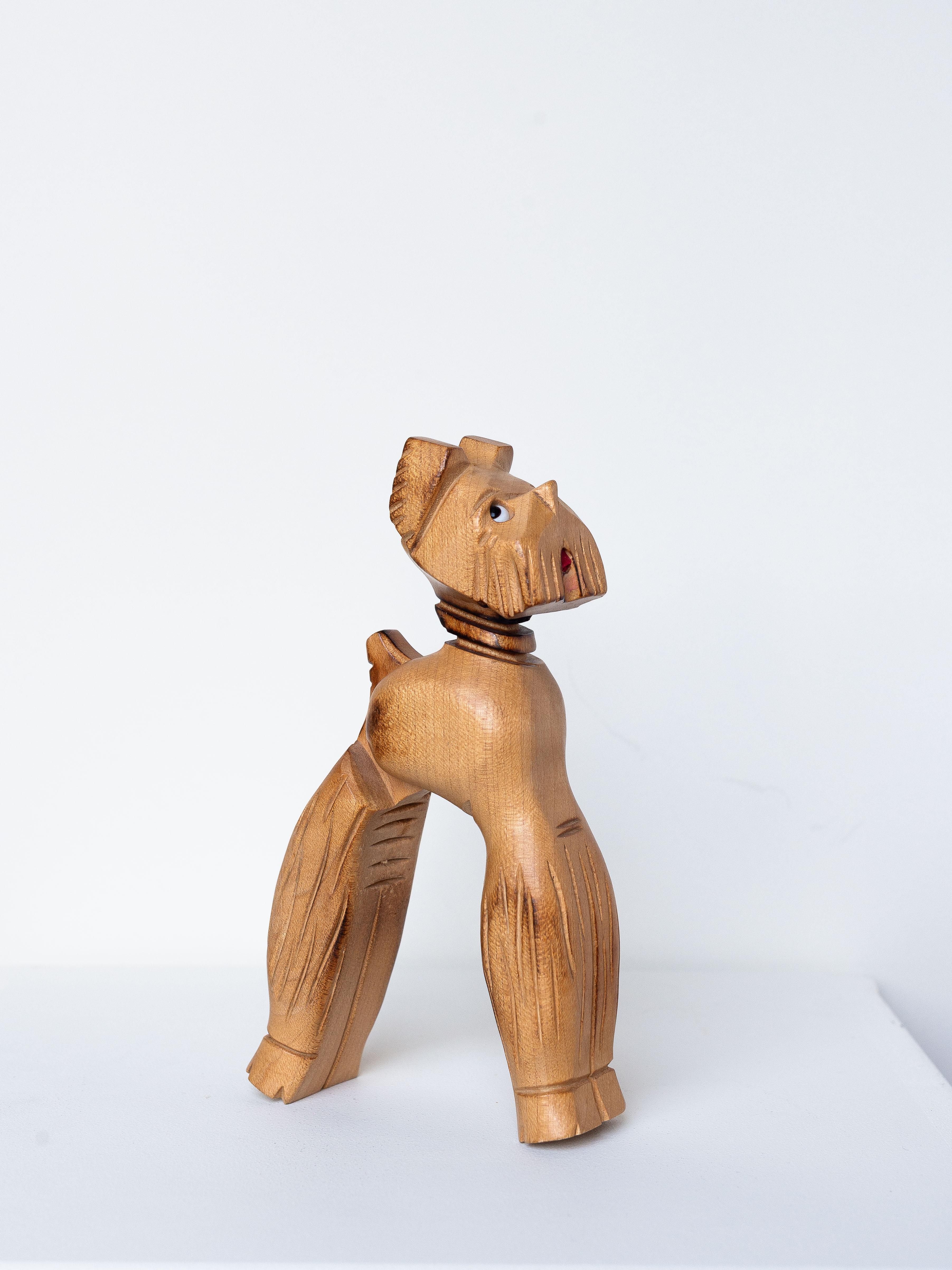 Wood Nutcracker, Dog Fox Terrier, France 1950s.

A rare and charming French-made nutcracker, shaped like a dog, very much likely a Fox Terrier.

Crafted from light-colored wood, its body and legs are hand-carved with simple, clean lines. 

The dog's