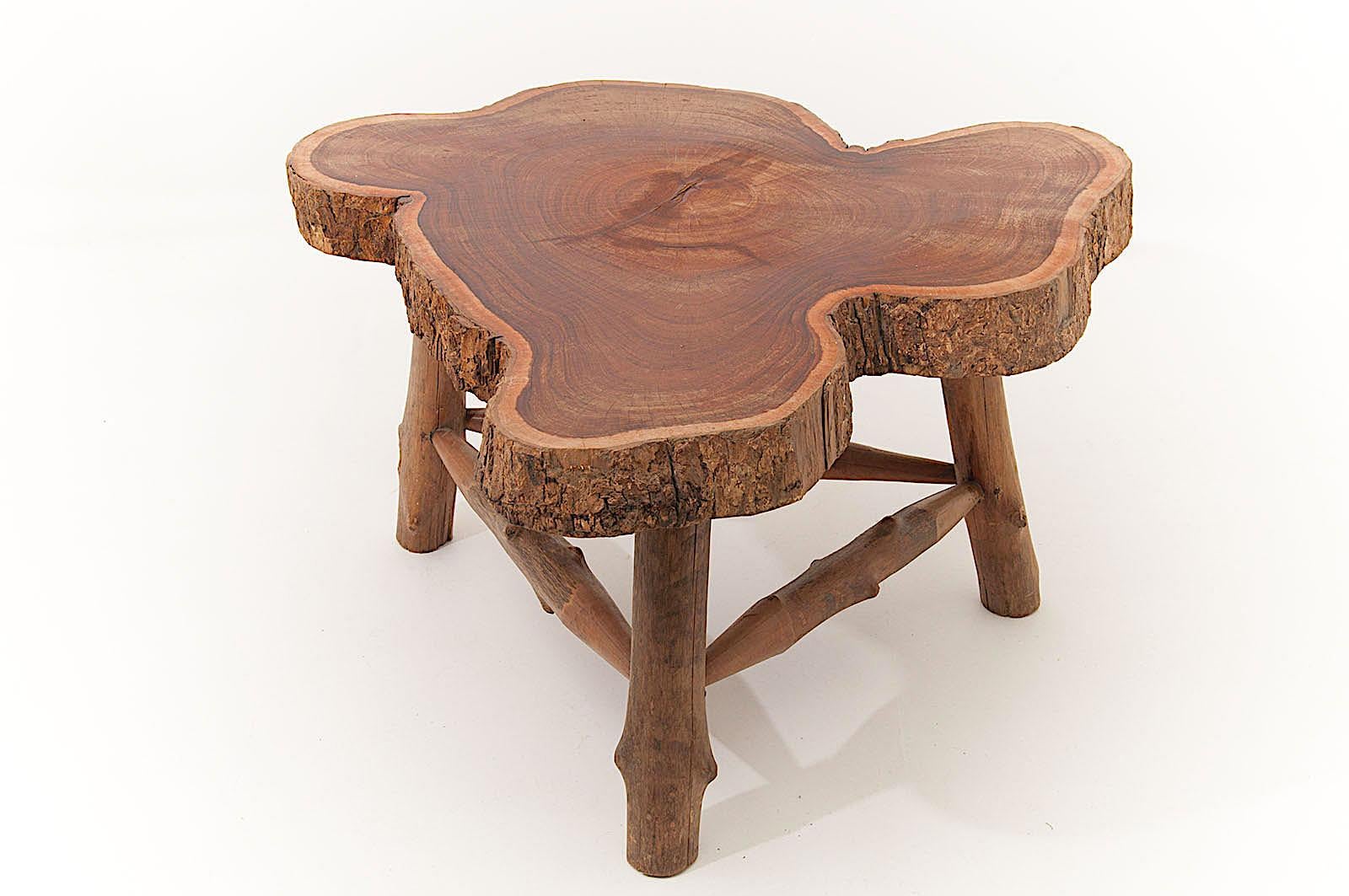 This table has organic free forms. It is in solid wood, with the apparent wood Bart on the slide. The three legs are in free form wood too. It keeps its natural colors, brown. This table has been made in France in the 1960s. Polished oil