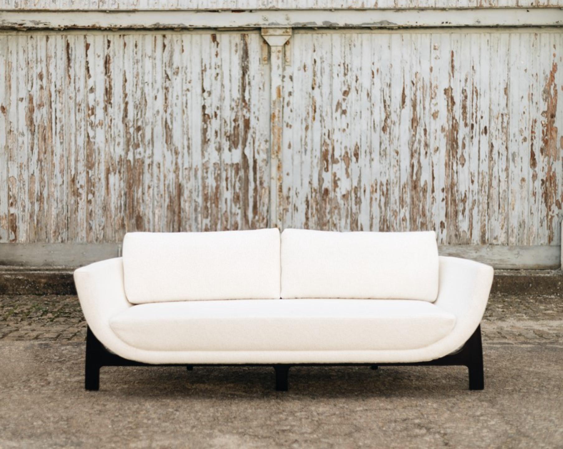 Wood Oscar Sofa by DUISTT 
Dimensions: W 210 x D 85 x H 76 cm
Materials: Fabric Pierre Frey Esteban Meringue, High Gloss Mahogany Wood

Inspired by the curved lines poetry of Oscar Niemeyer’s architecture, the OSCAR wood sofa allures for its sensual