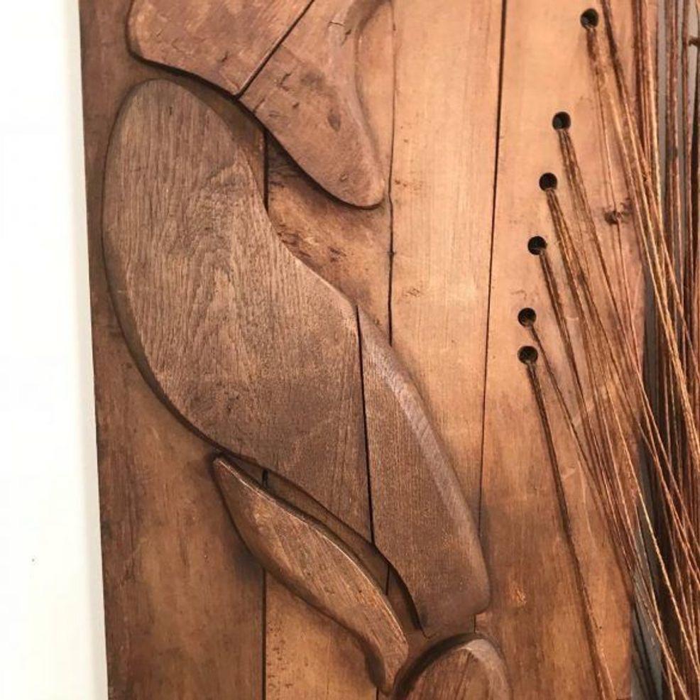 French midcentury decorative carved wood wall panel depicting an abstracted nude woman in the pose of a diver. The piece has an organic and sensuous quality. A panel of knotted and braided fibrous materials adds an element of earthy, tactile