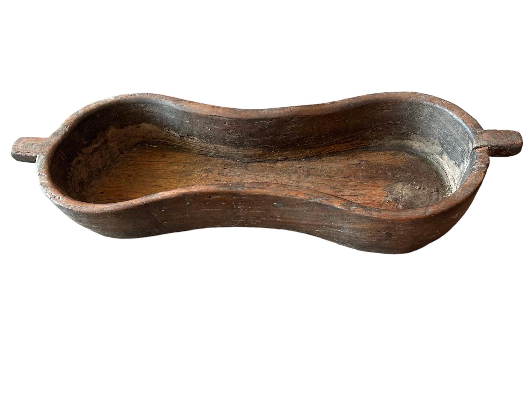 Beautifully made peanut shaped trough, believed to be from South America by original owners but not confined. It has a cool feeling as the wood is smooth to the hands but beautifully worn
Hard wood tray. Hand made.
