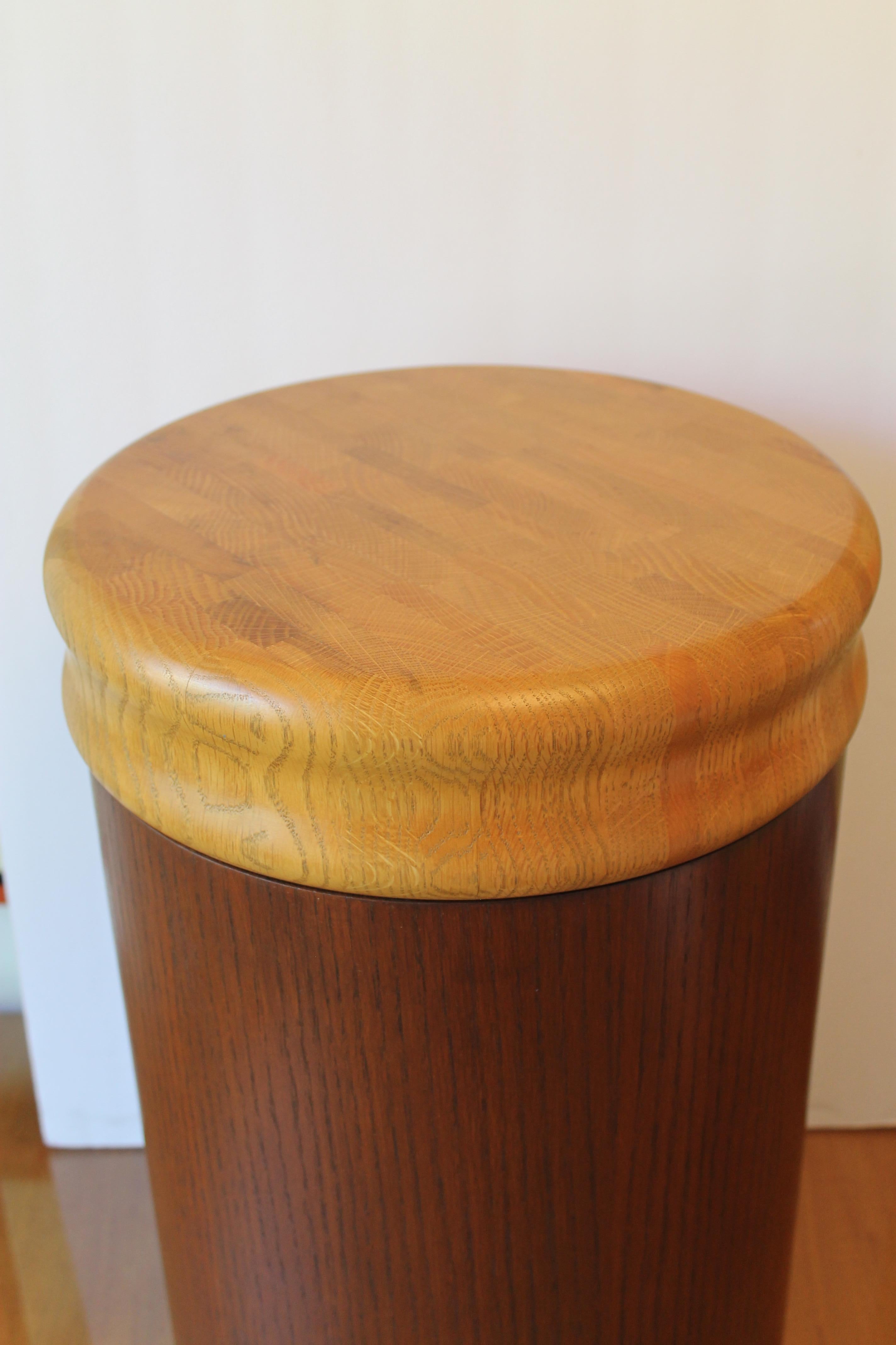 Pedestal with cutting board top. Possibly a Danish design. It can be used as a stool, storage container or pedestal. The wood top is 3.5” high and 12.5” diameter. The base is 15.75” high and 12” diameter. Once top is added the total height is 18.75”.