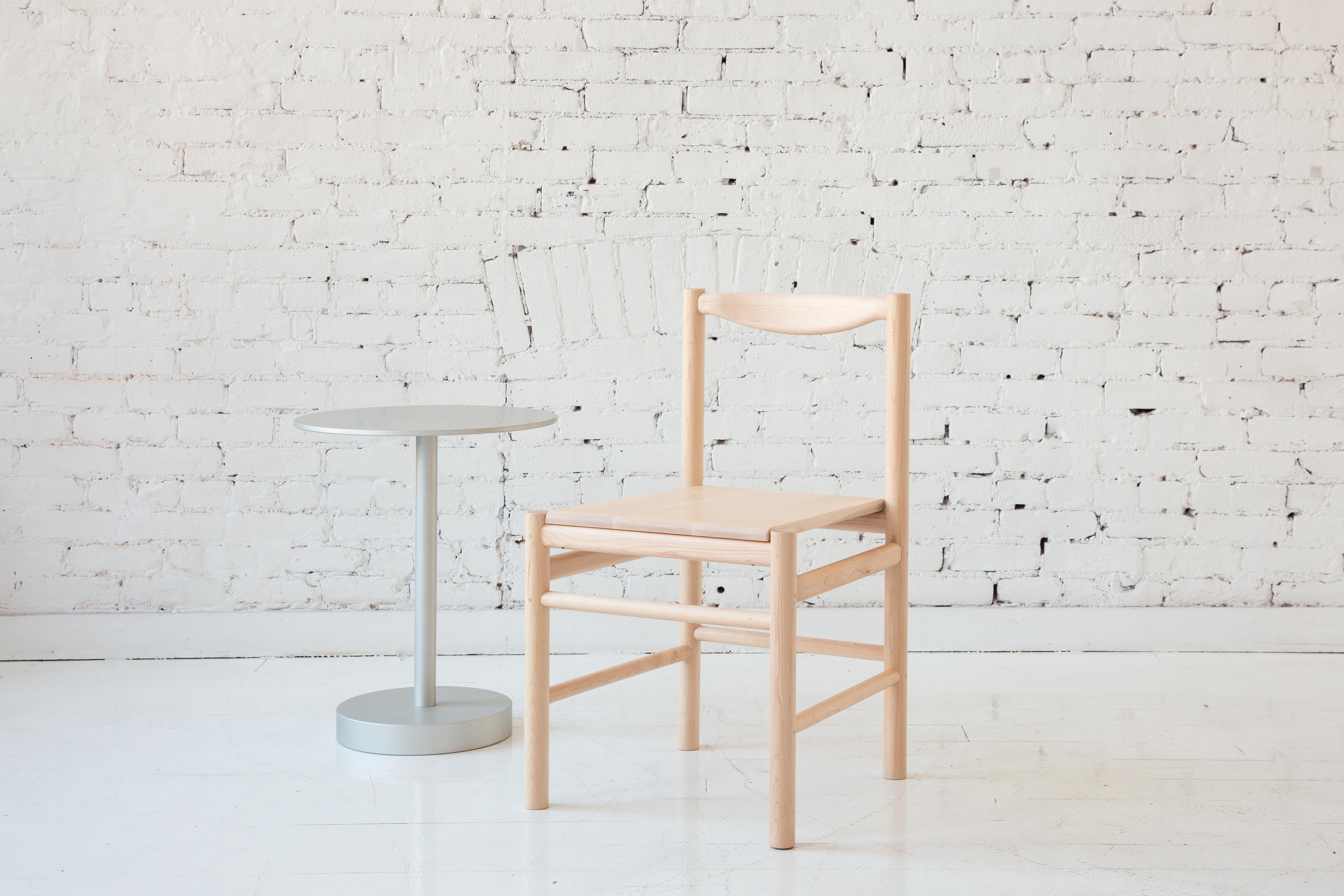 Shaker inspired wood side chair with comfortable contoured back rest. Option for a plain wooden seat pan or a seat pan with a low profile leather or shearling pad. This chair's simplicity makes it versatile to work perfectly in many different