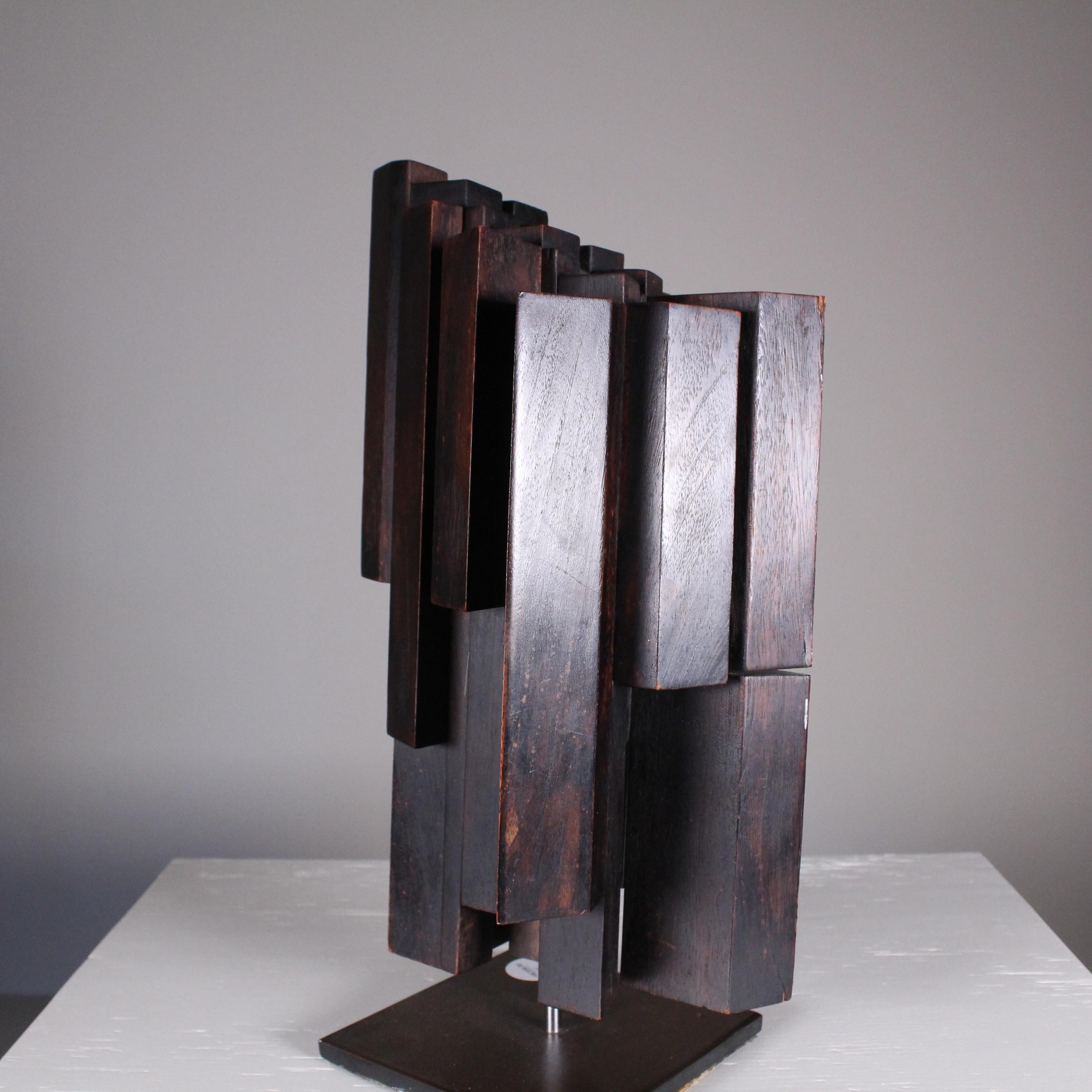 Sculpture made of black painted wood and metal pedestal. Good overall condition, howeverap resents swgni of wear and tear due to time. 