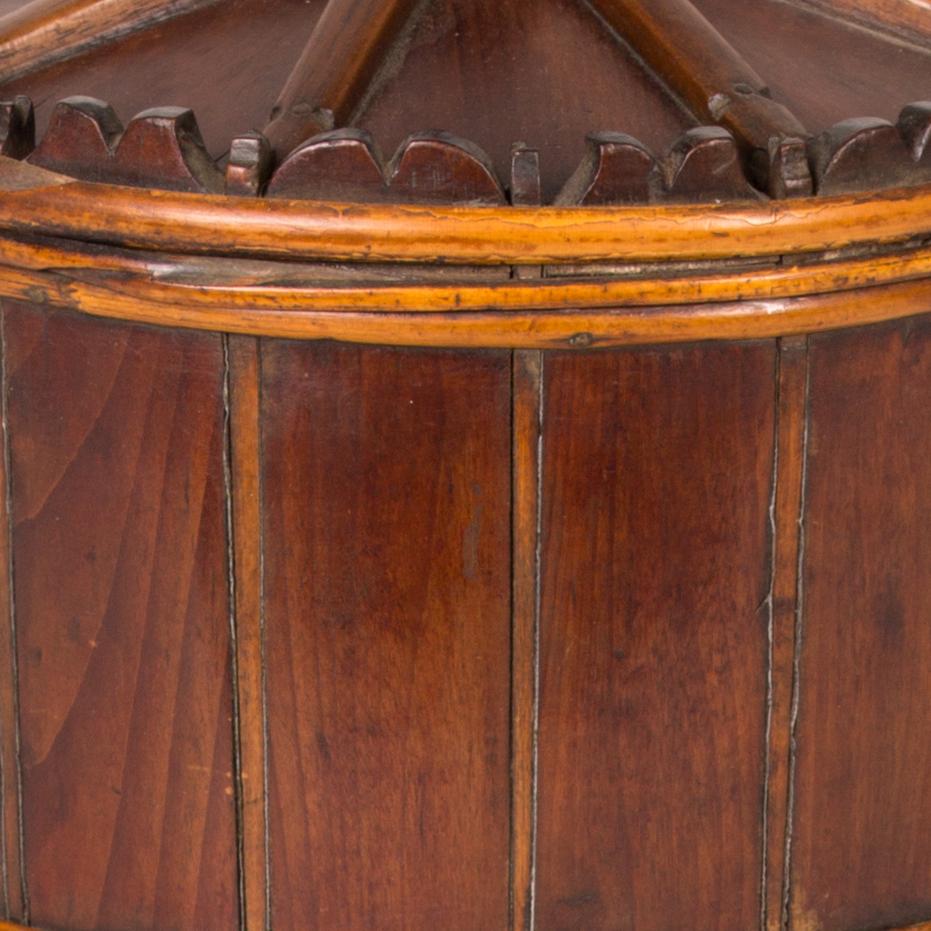 19th-century Swedish wooden spice bucket with eight interior dividers for separating spices. Both functional and decorative at once, the piece has a drum-like shape, bat and board siding, beveled skirt and cornice and raised mushroom-shaped handle.