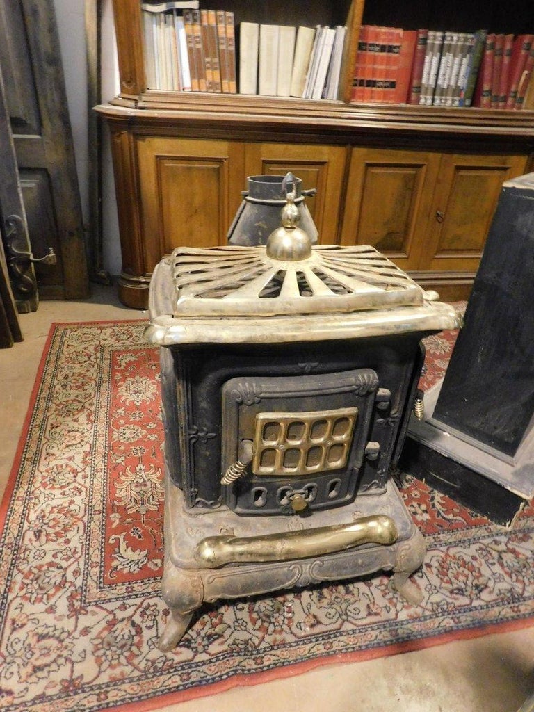 Wood stove, branded Parlor Stove, in black cast iron, gold-plated brass  finishes, image size:768x1024