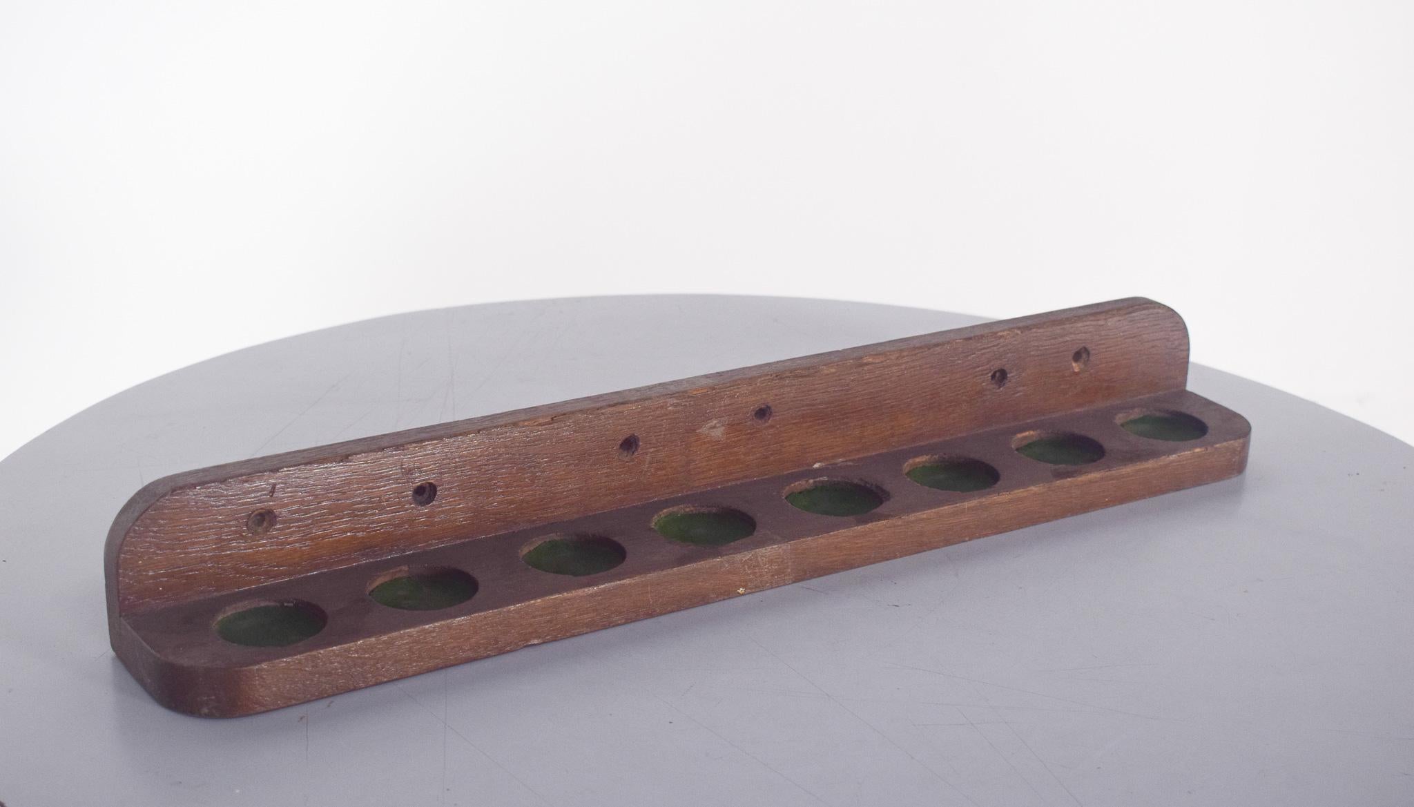 Wooden Support for Snooker or Billiard Cues. Designed to be fixed to the wall, allowing you to organize and store your clubs in a practical way. The piece has a base with circular holes covered with green felt, where the tips of the sticks are