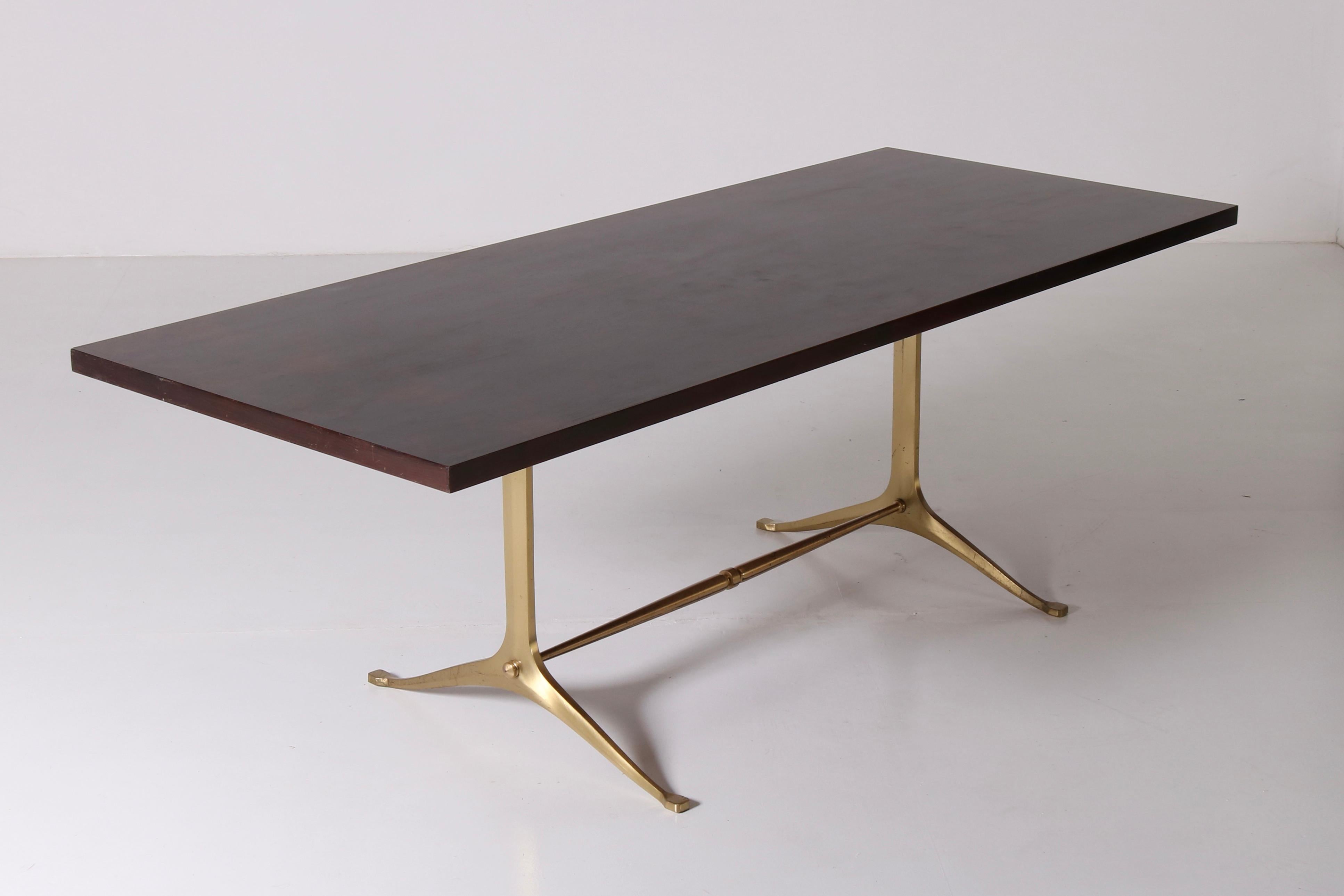This Melchiorre Bega table from 1960s  perfectly embodies Italian design's timeless elegance and commitment to merge aesthetics and functional excellence. Characterized by meticulous craftsmanship, the table features a wood structure with brass