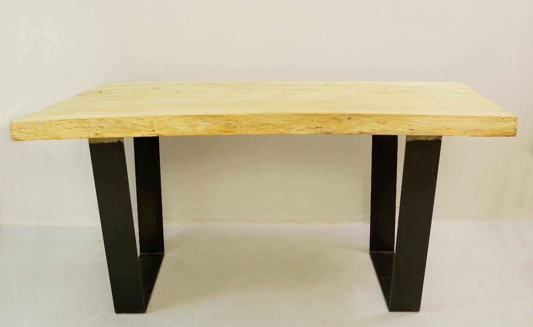 Wood top dining table with metal legs.